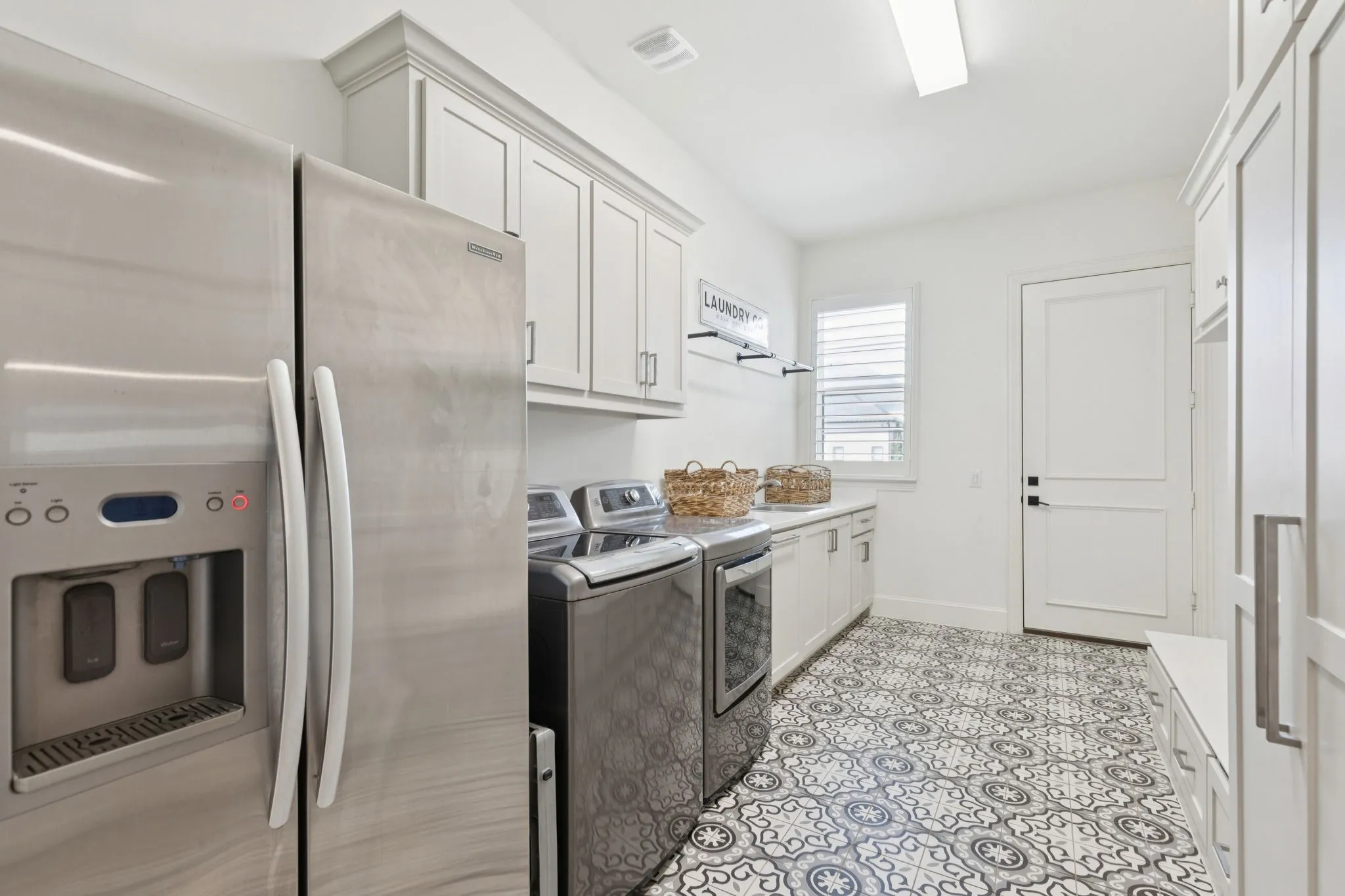 Laundry room featuring washing machine and clothes dryer and cabinet space