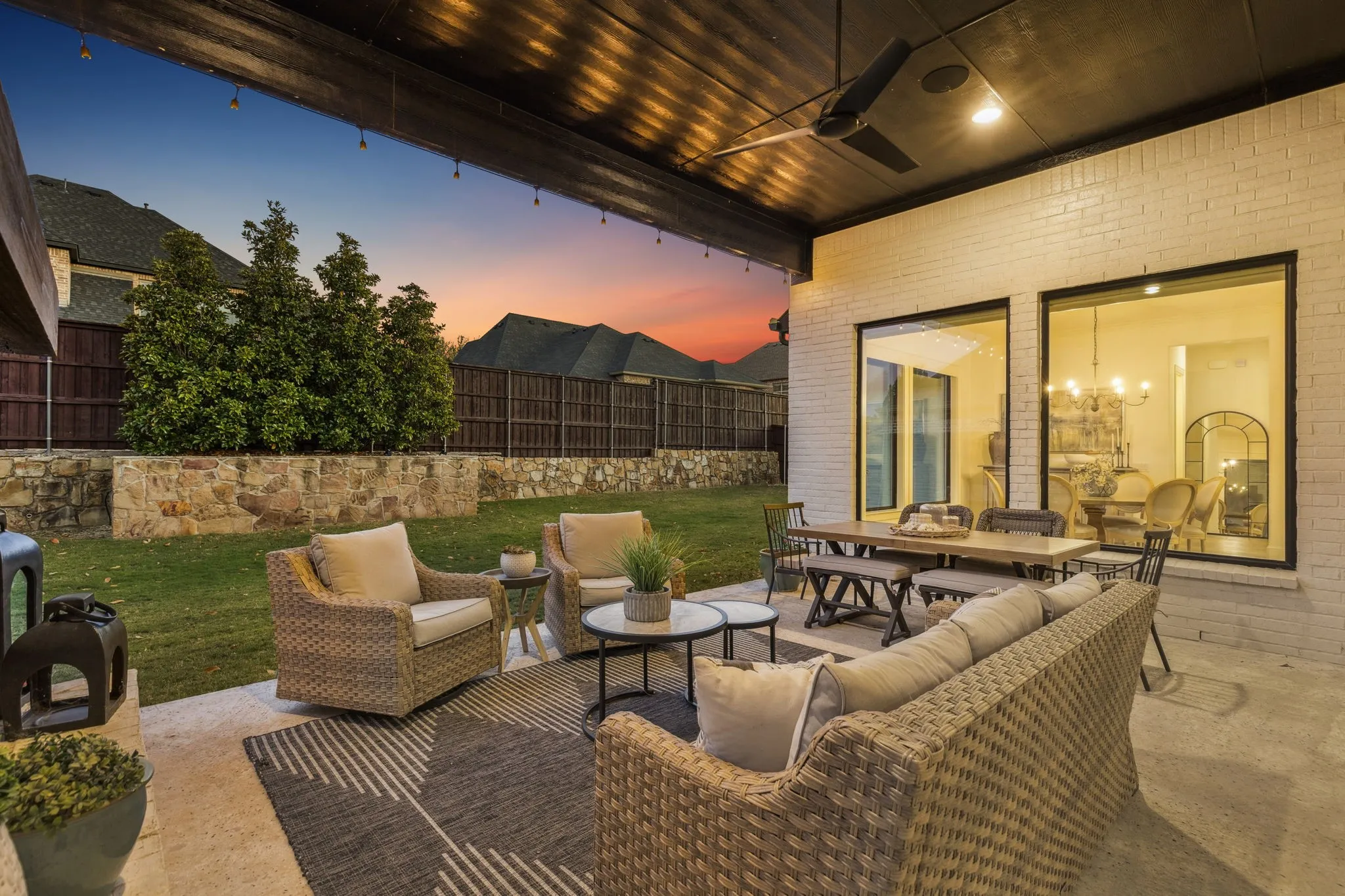 Patio terrace at dusk with an outdoor living space, a fenced backyard, a patio area, and outdoor dining space