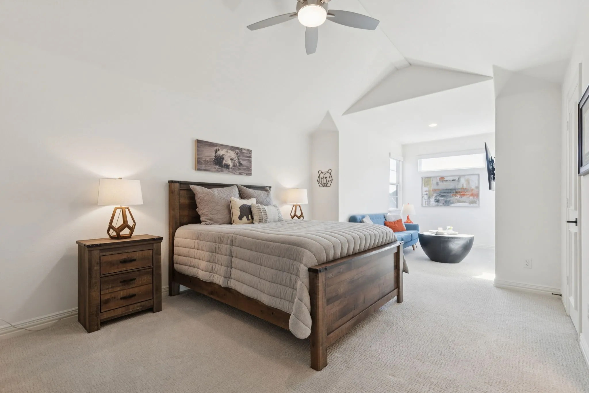 Bedroom with light carpet, lofted ceiling, and a ceiling fan