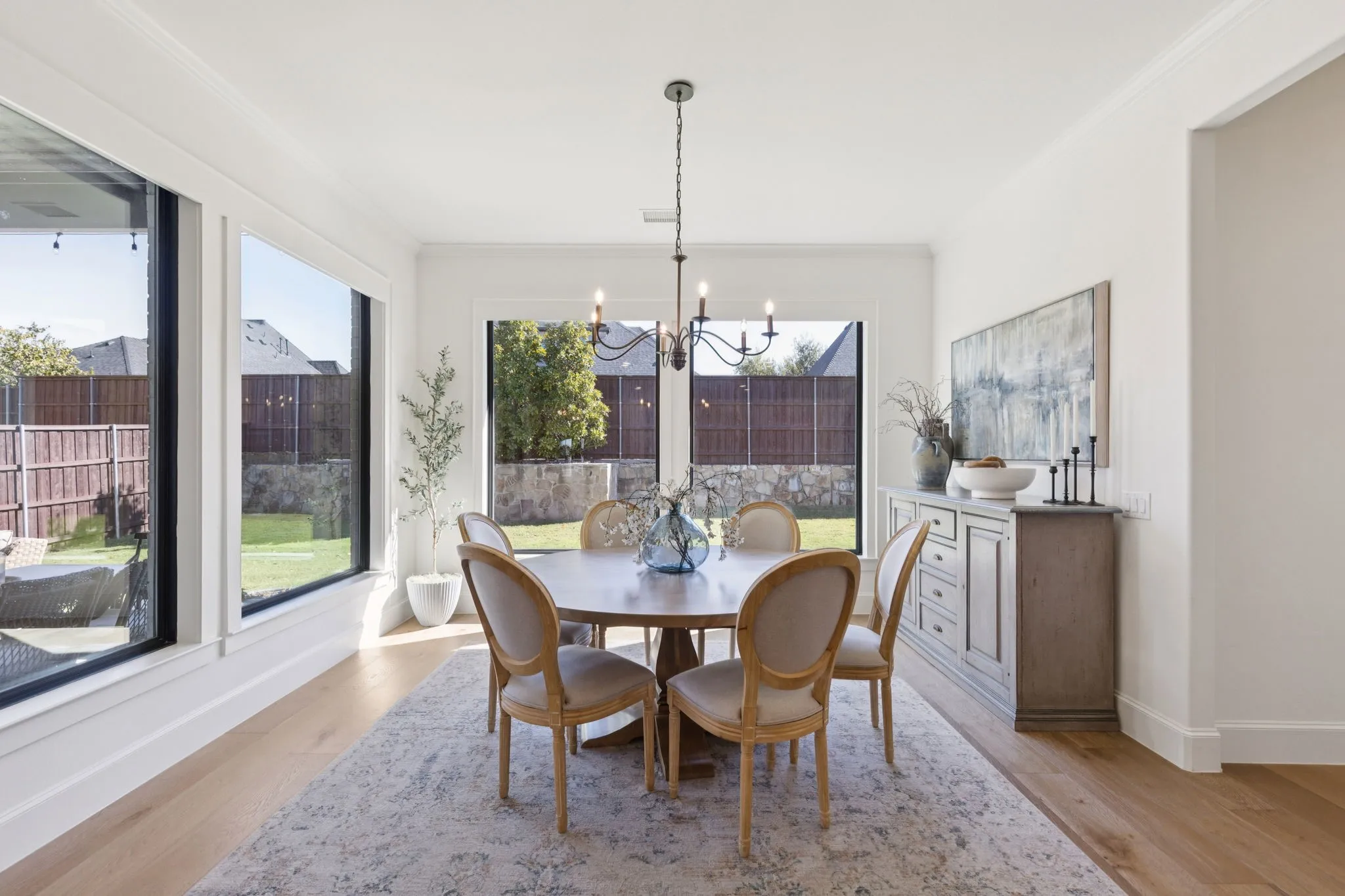 Dining space featuring light wood-type flooring, ornamental molding, and a chandelier