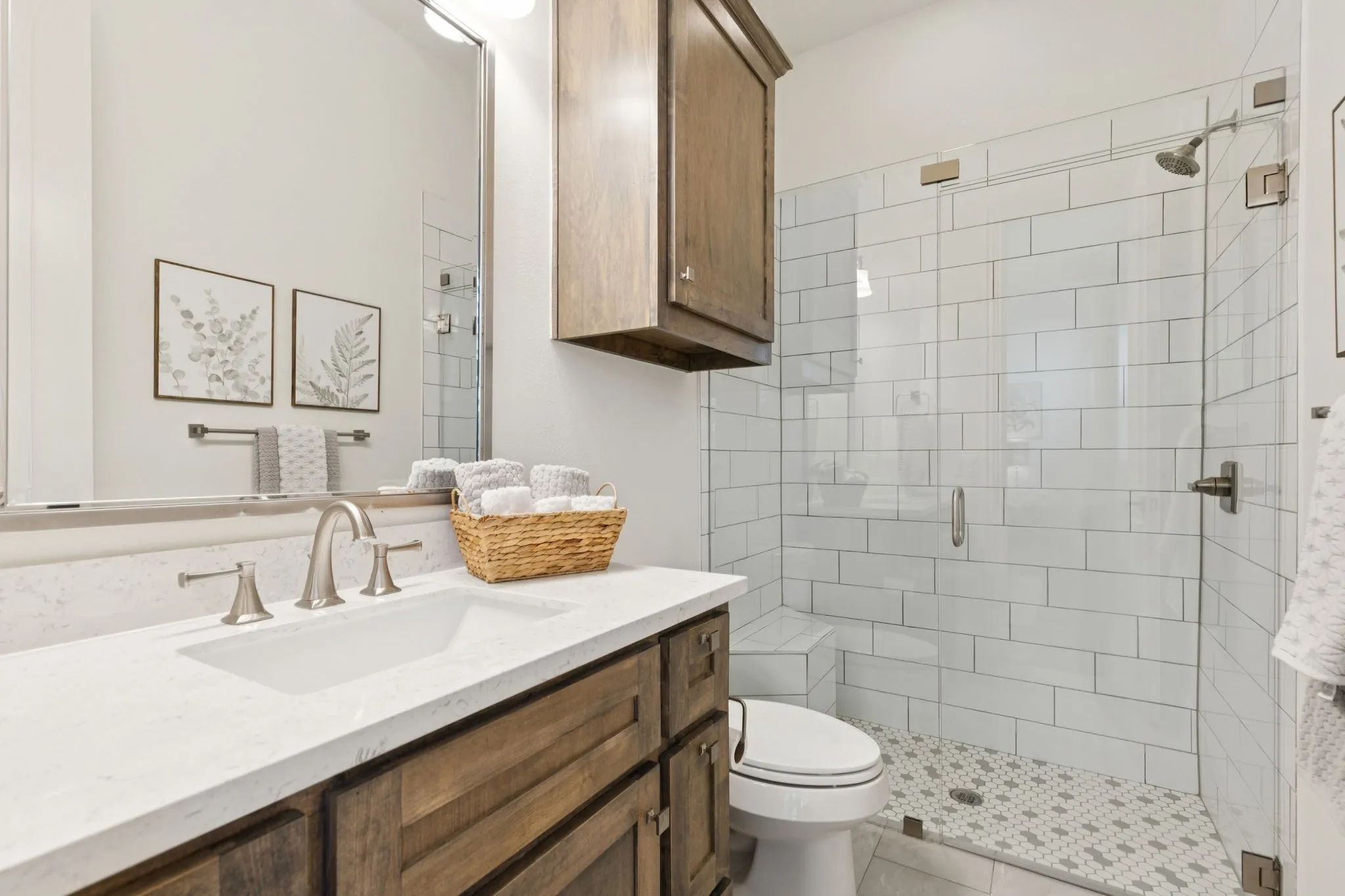 Bathroom with vanity, a shower stall, and tile patterned flooring