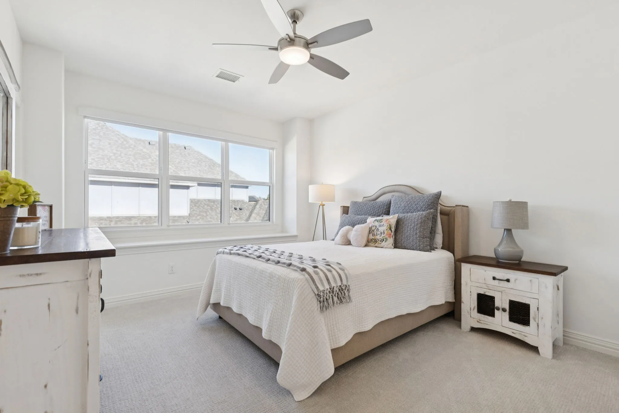 Bedroom with light carpet and ceiling fan