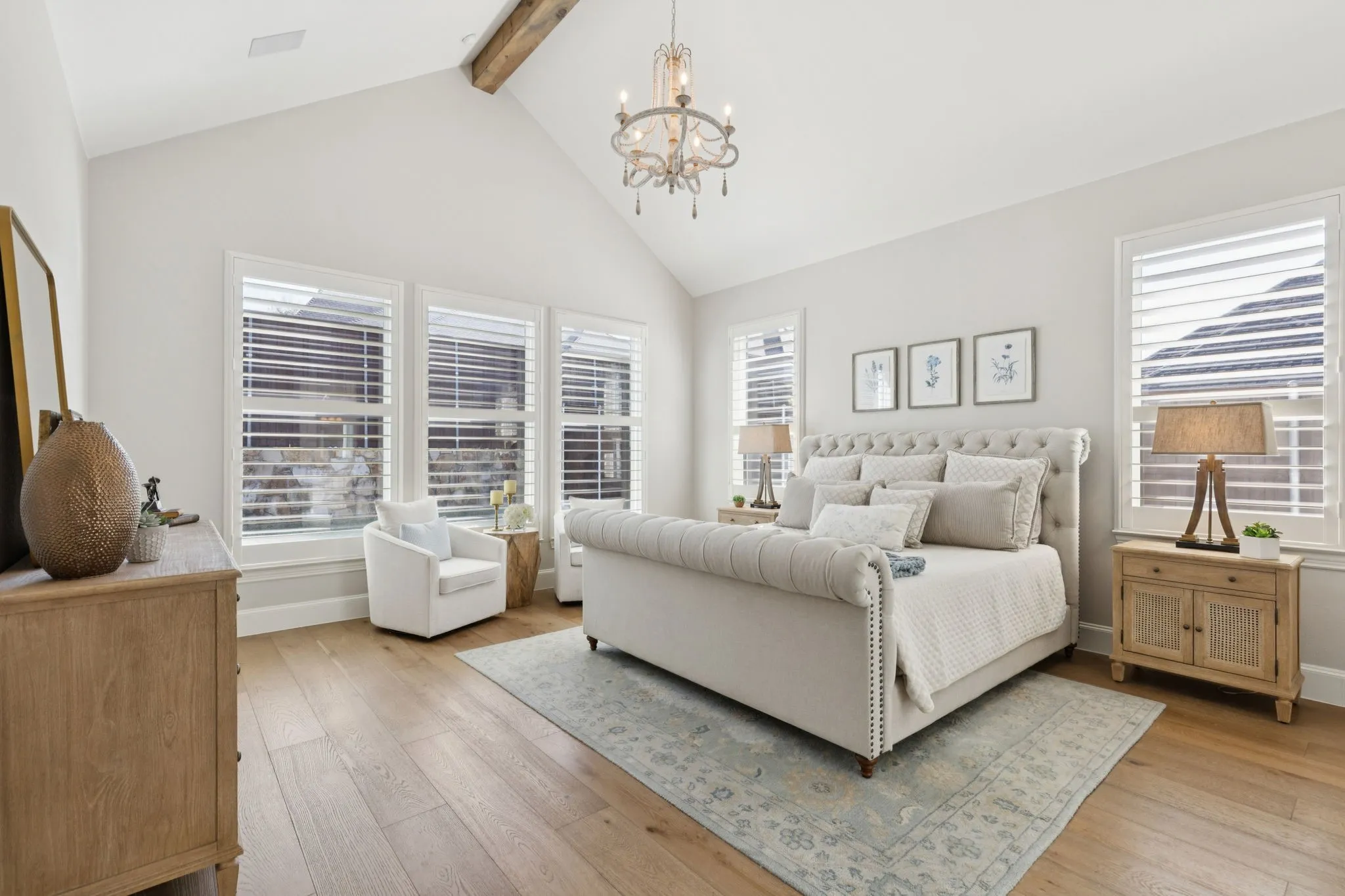 Bedroom featuring a chandelier, beam ceiling, light wood-type flooring, and high vaulted ceiling