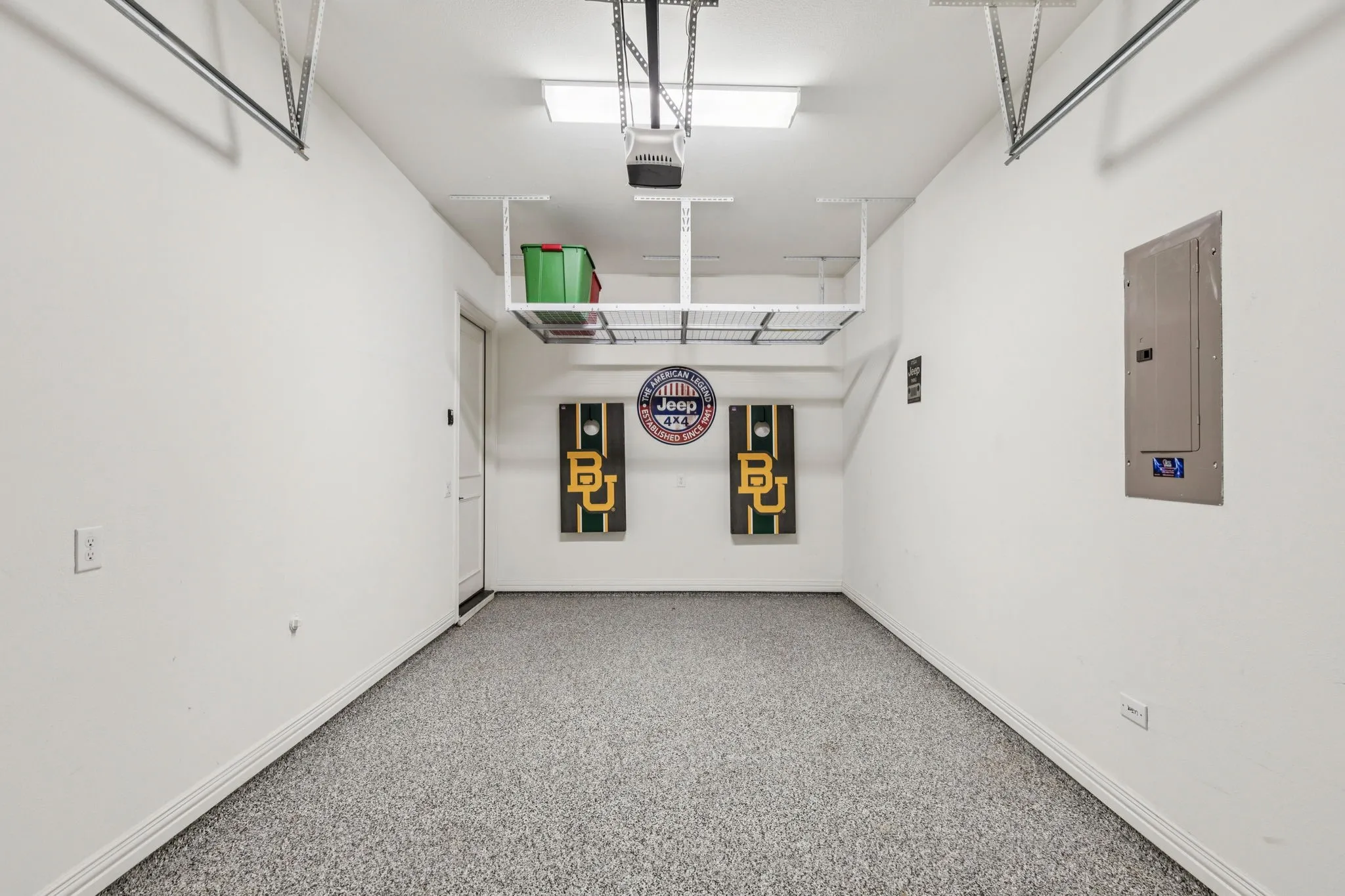 Garage with electric panel and a garage door opener