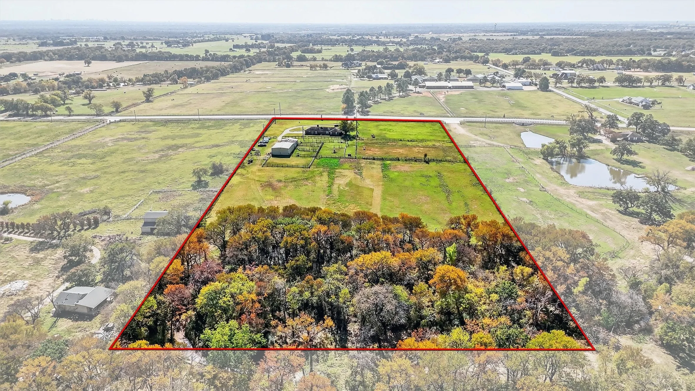 Overview of rural landscape featuring a nearby body of water and property parcel outlined