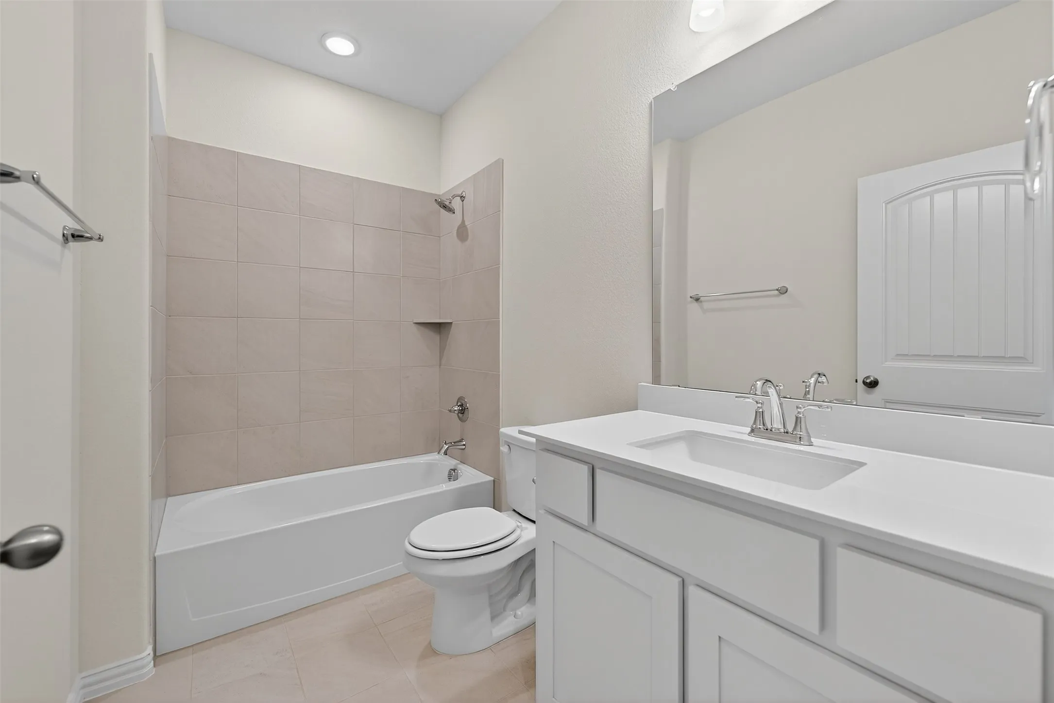 Full bathroom with tub / shower combination, vanity, and light tile patterned floors