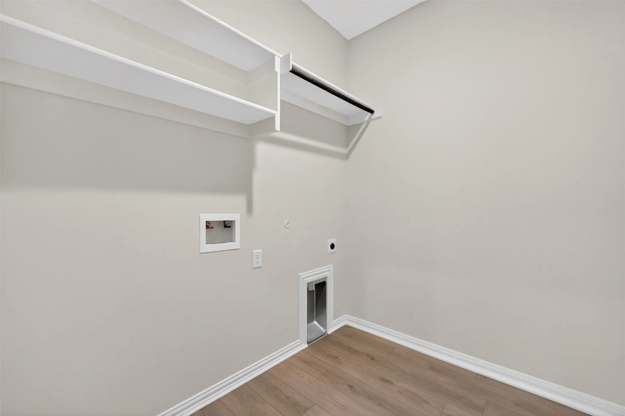 Laundry room with gas dryer hookup, light wood-style floors, hookup for an electric dryer, and hookup for a washing machine