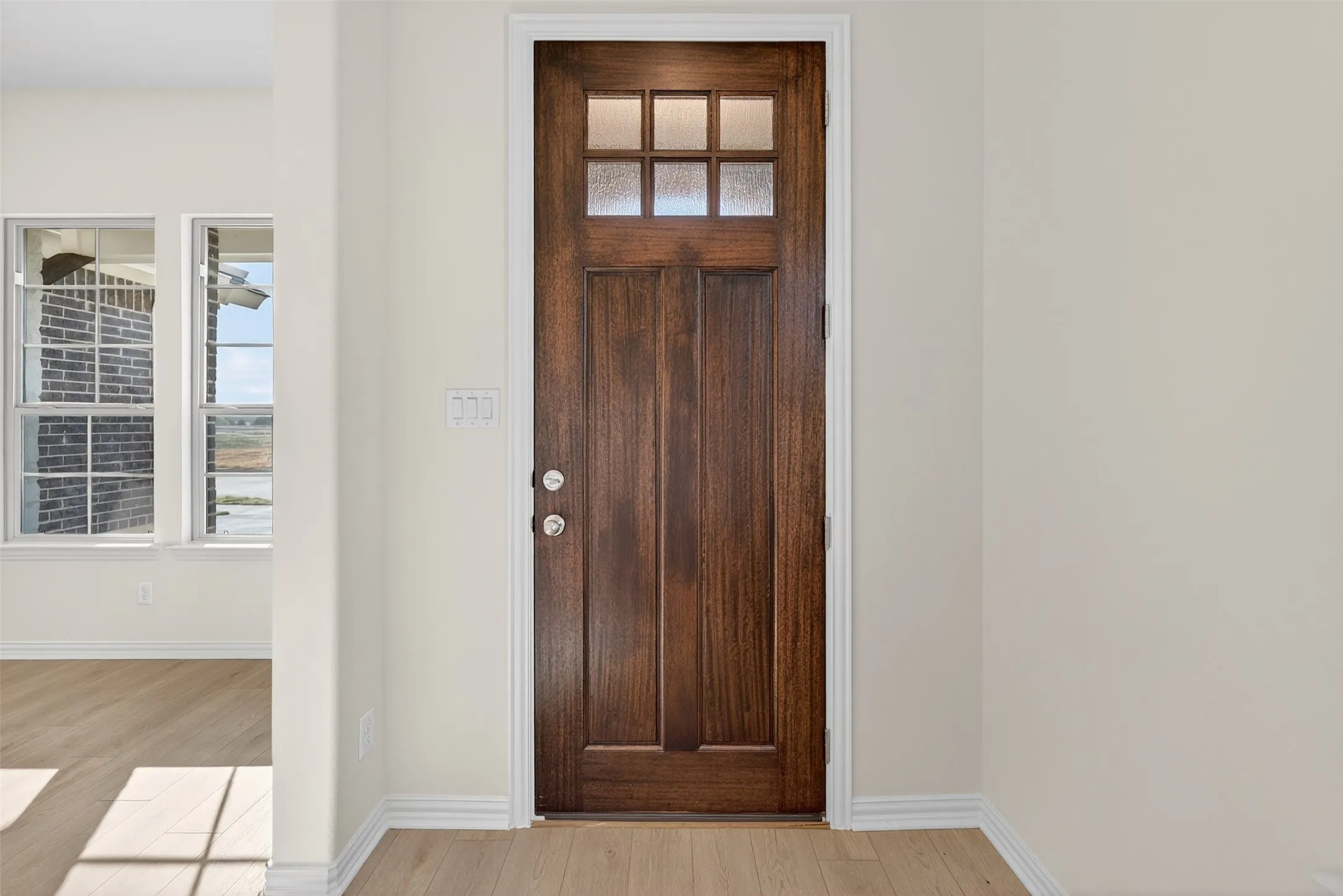 Foyer entrance with healthy amount of natural light and light wood finished floors