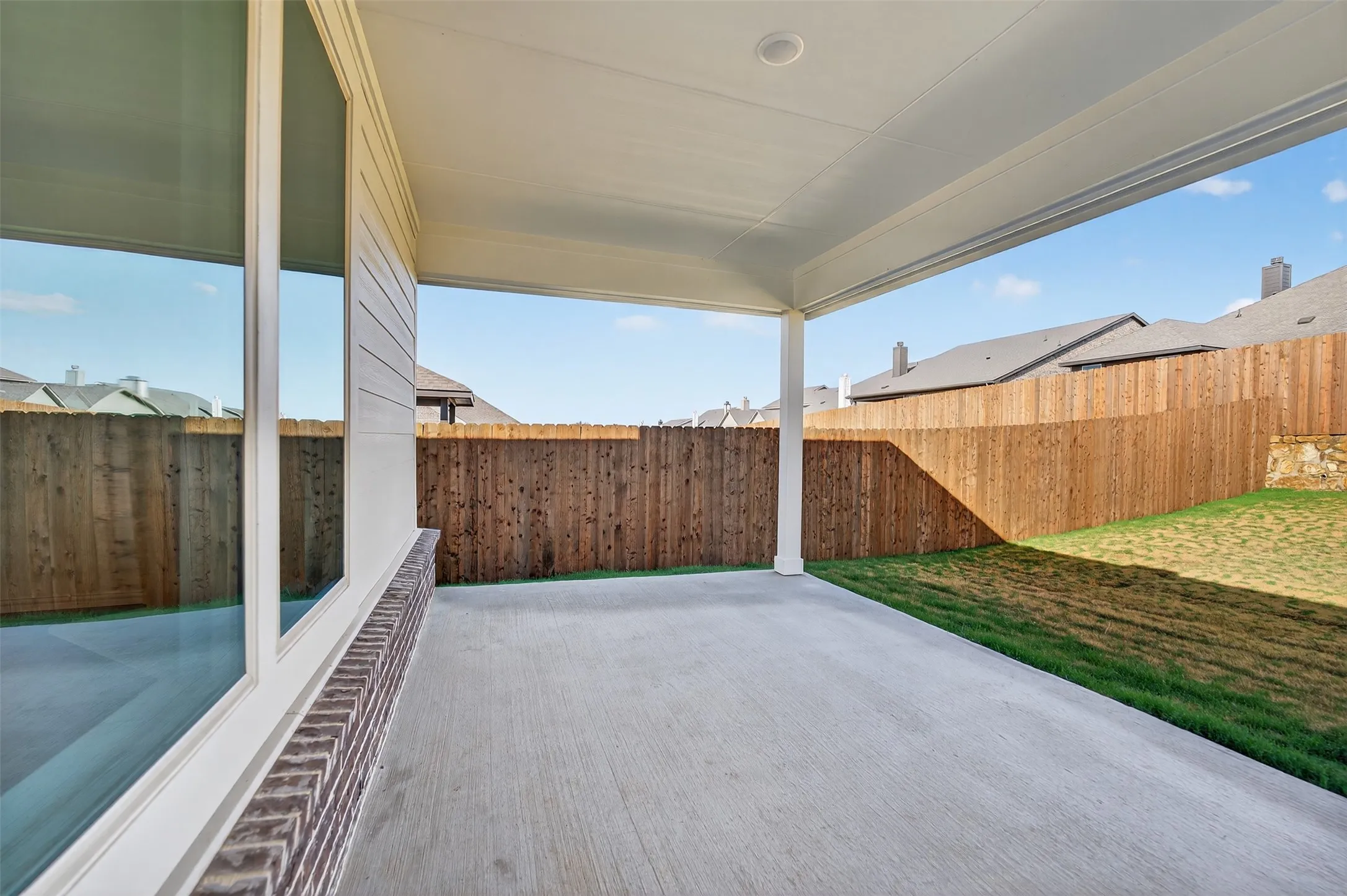 Fenced backyard featuring a patio