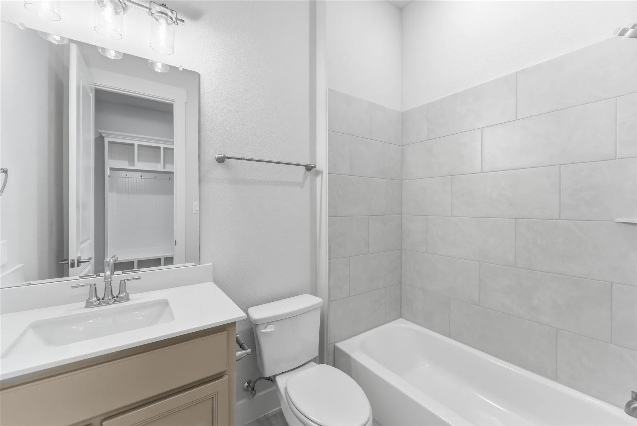Full bath featuring vanity and washtub / shower combination