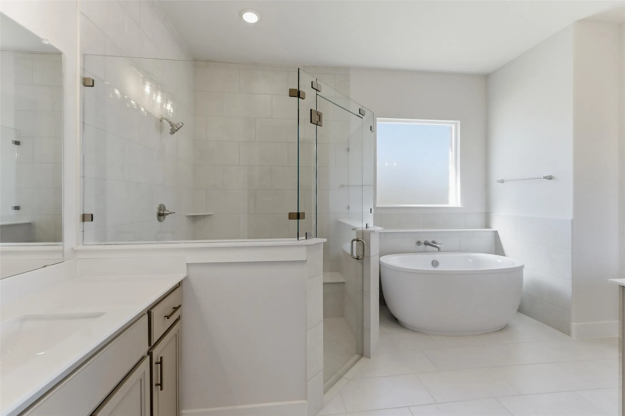 Full bathroom featuring vanity, a stall shower, a soaking tub, tile walls, and light tile patterned floors