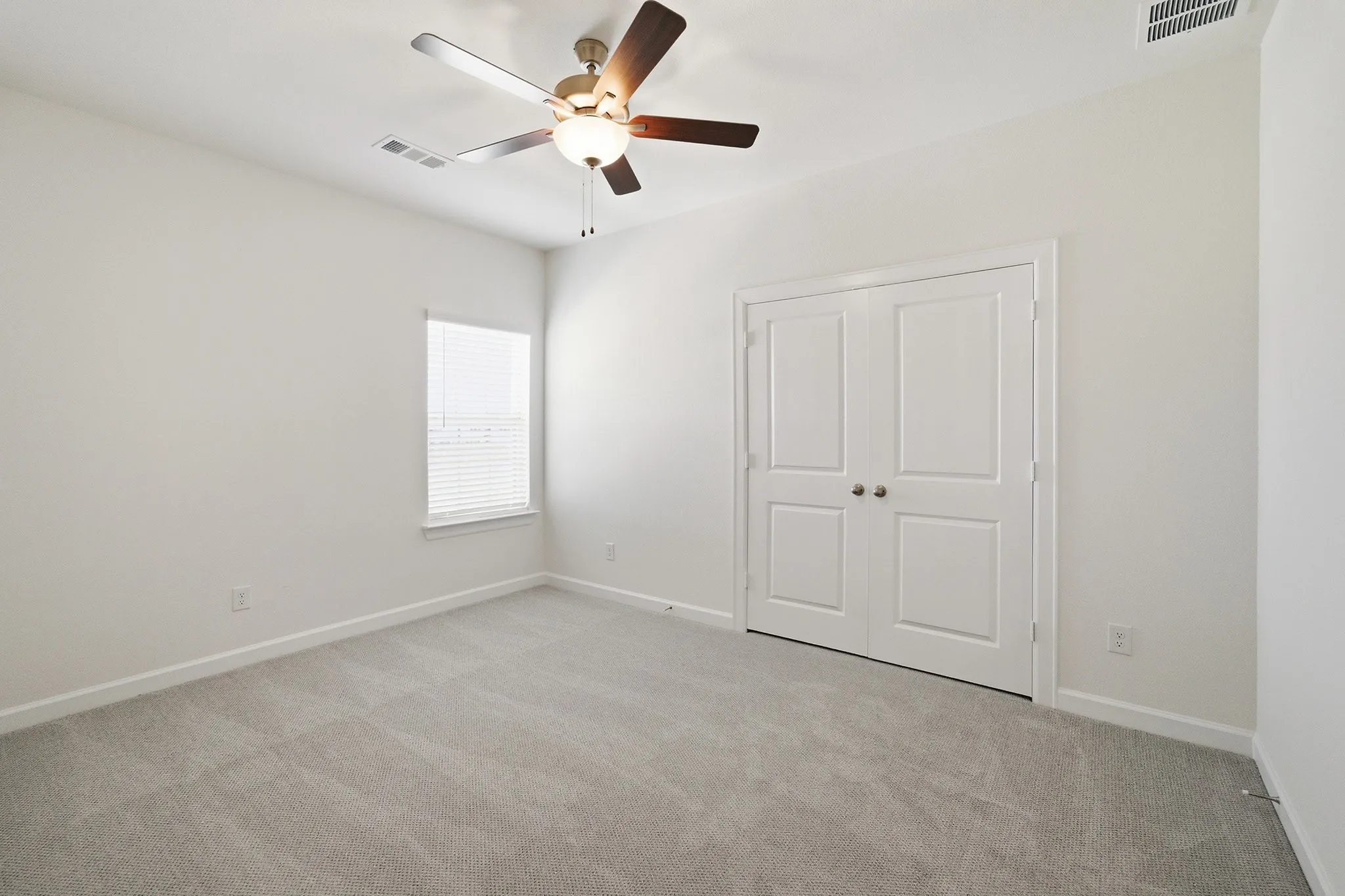 Neutral wall color complemented by light gray carpeting