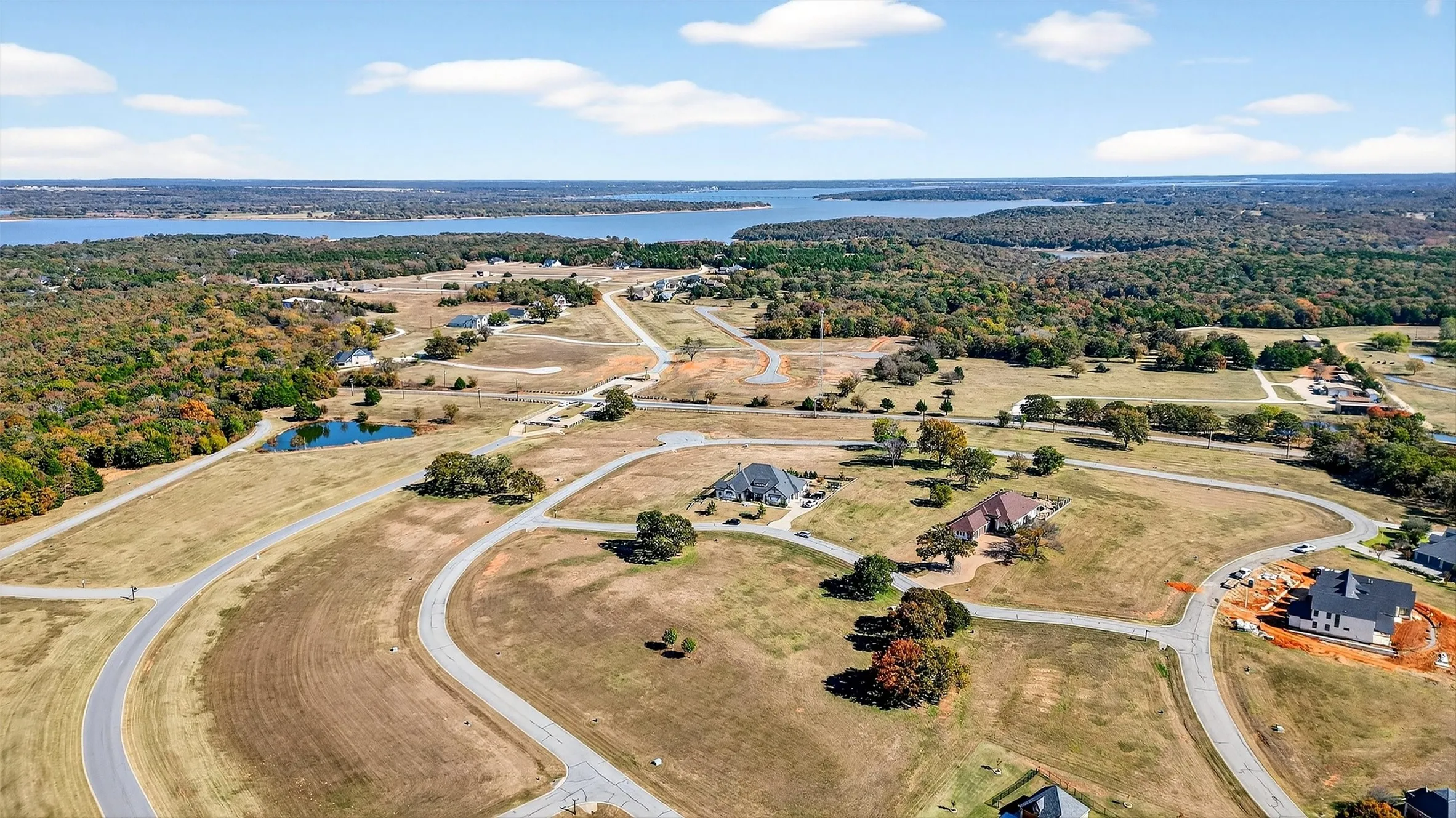 Bird's eye view of a nearby body of water and a heavily wooded area