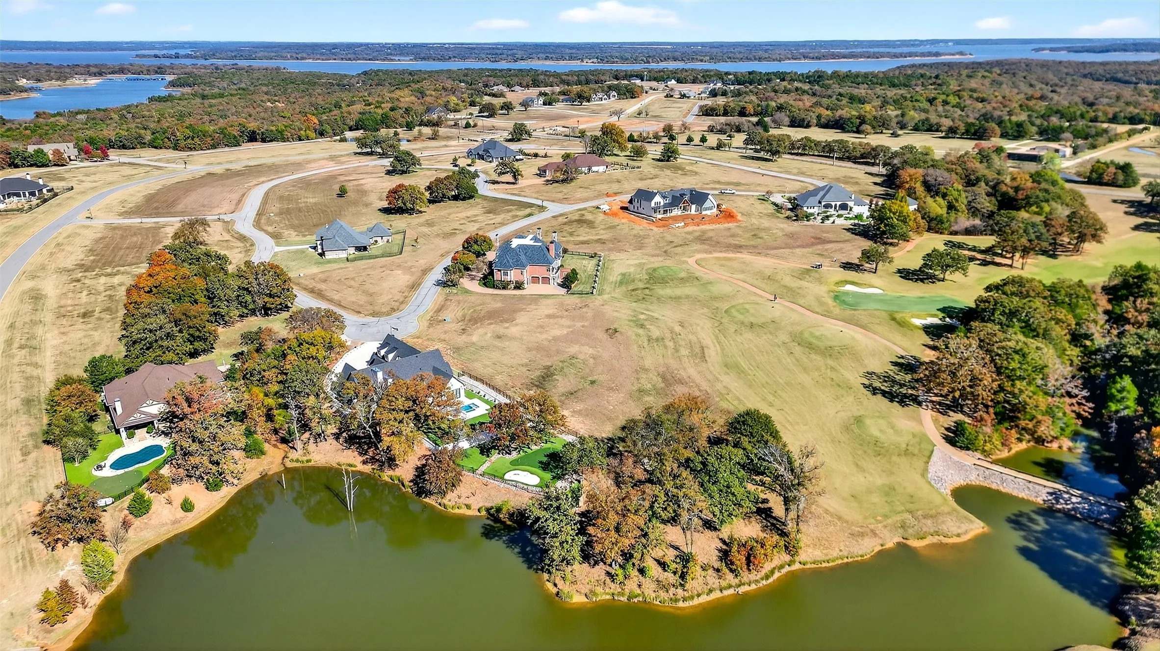 Aerial view of property and surrounding area with a nearby body of water