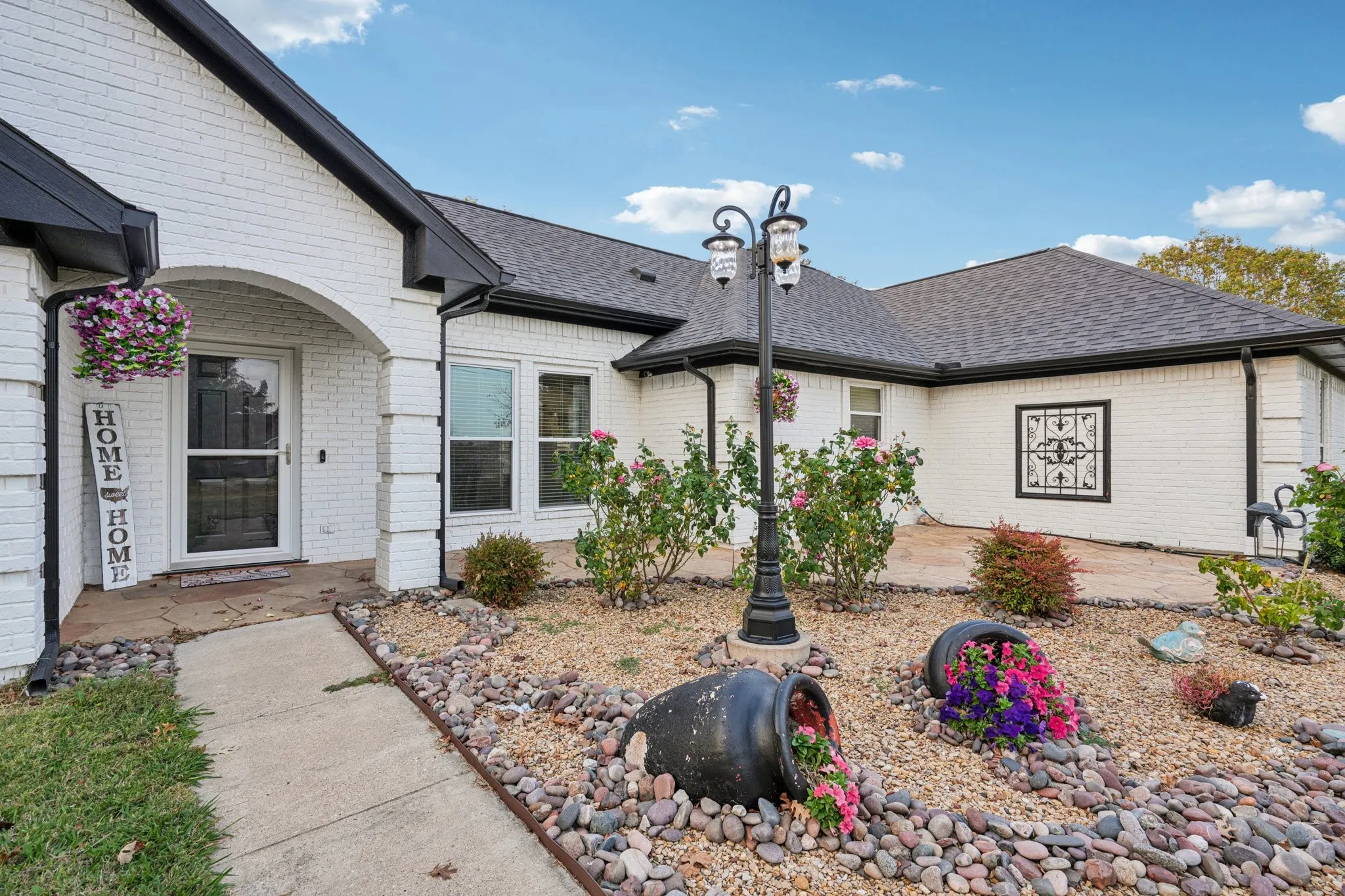 cute Front Patio with lovely rose garden ready for furniture and a cup of coffee