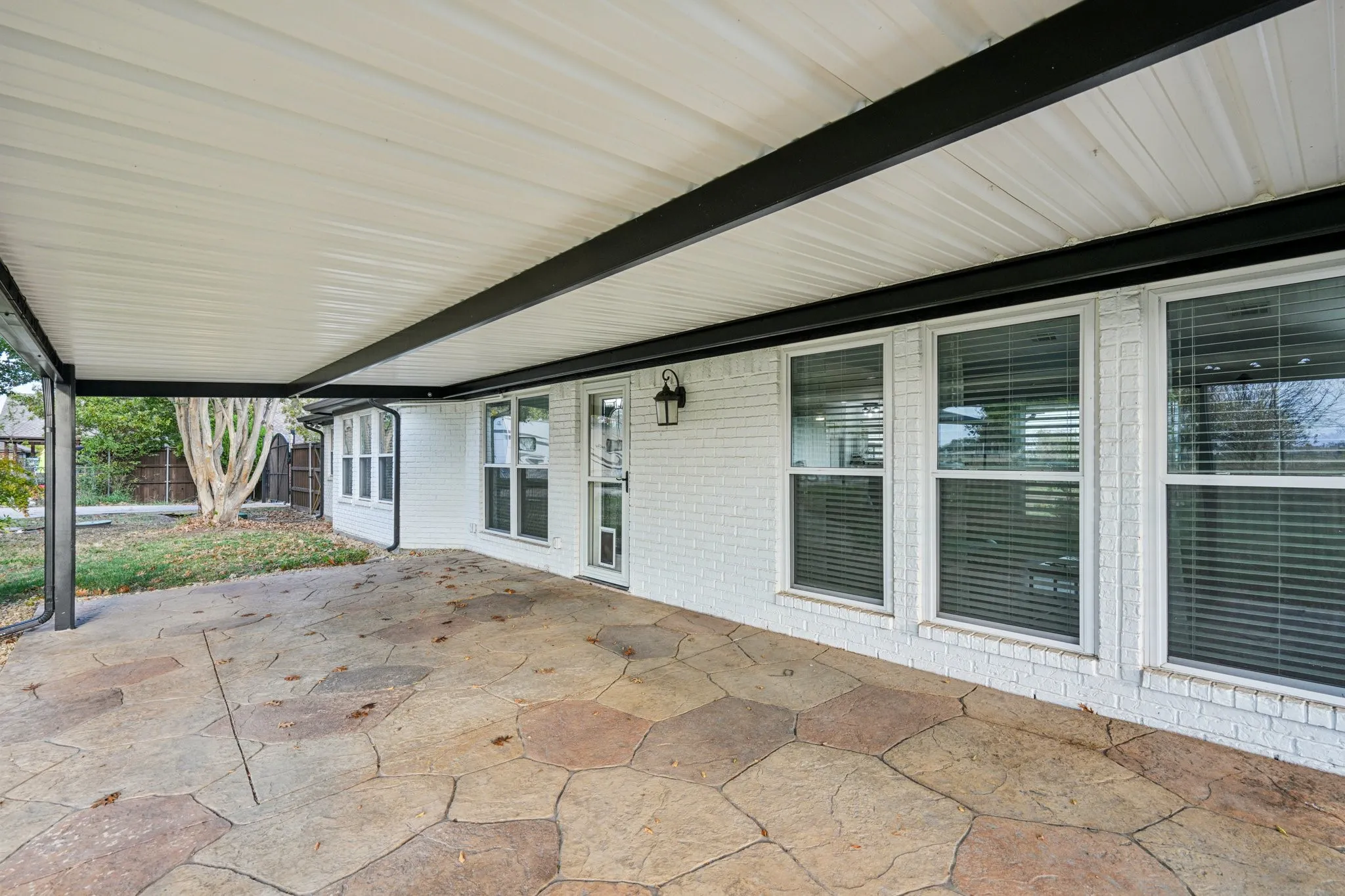 View of large covered Patio with stamped concrete
