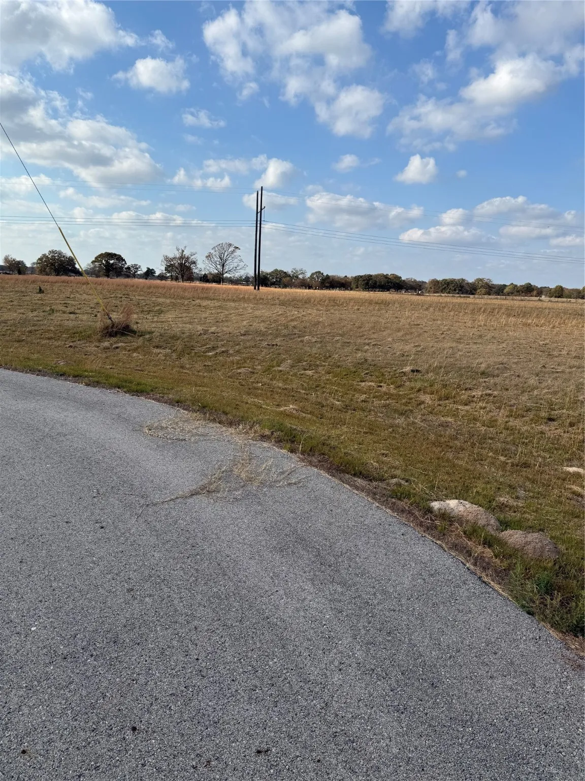 View of asphalt road featuring a view of countryside