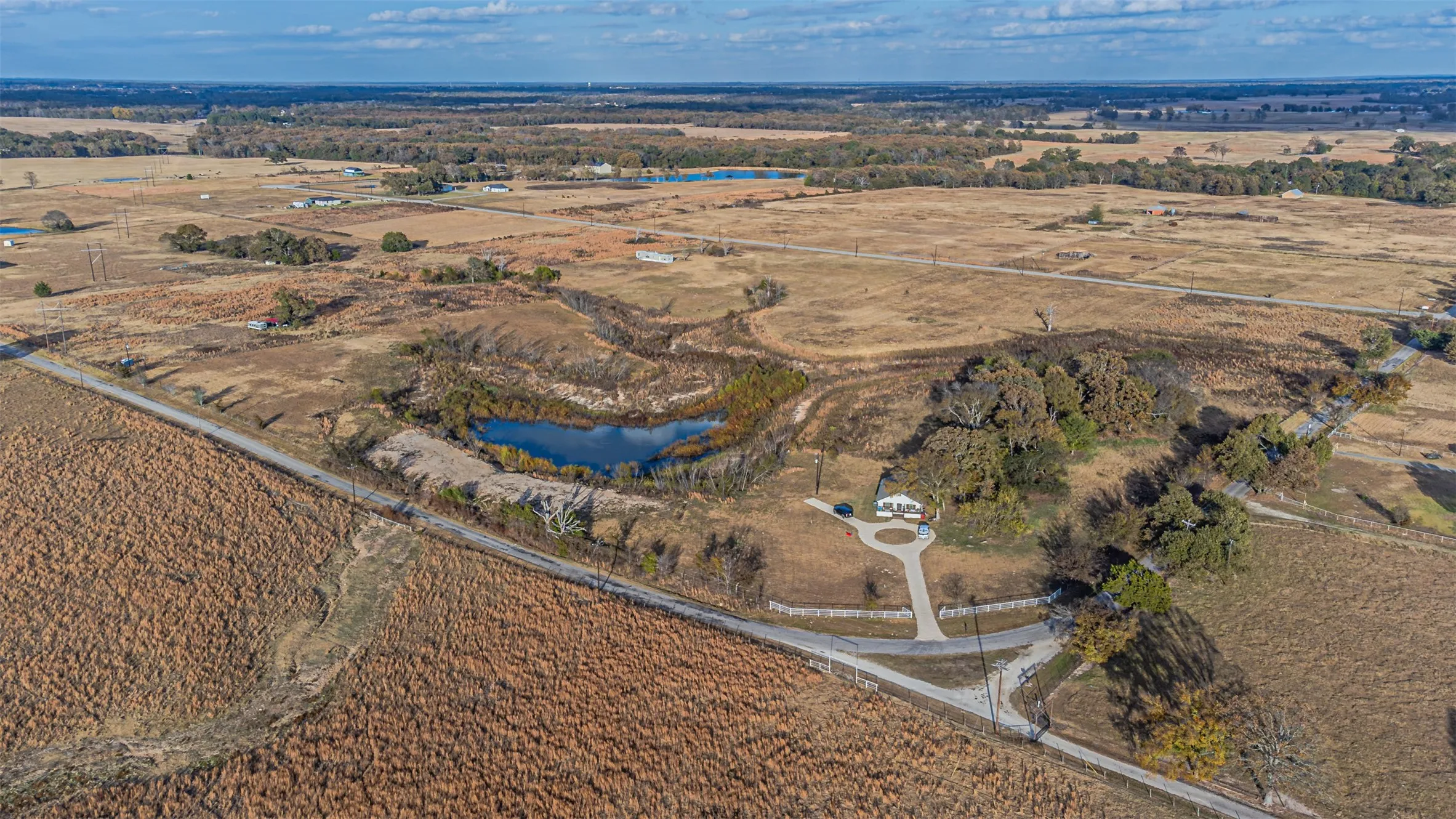 Aerial view of property's location featuring rural landscape and a nearby body of water