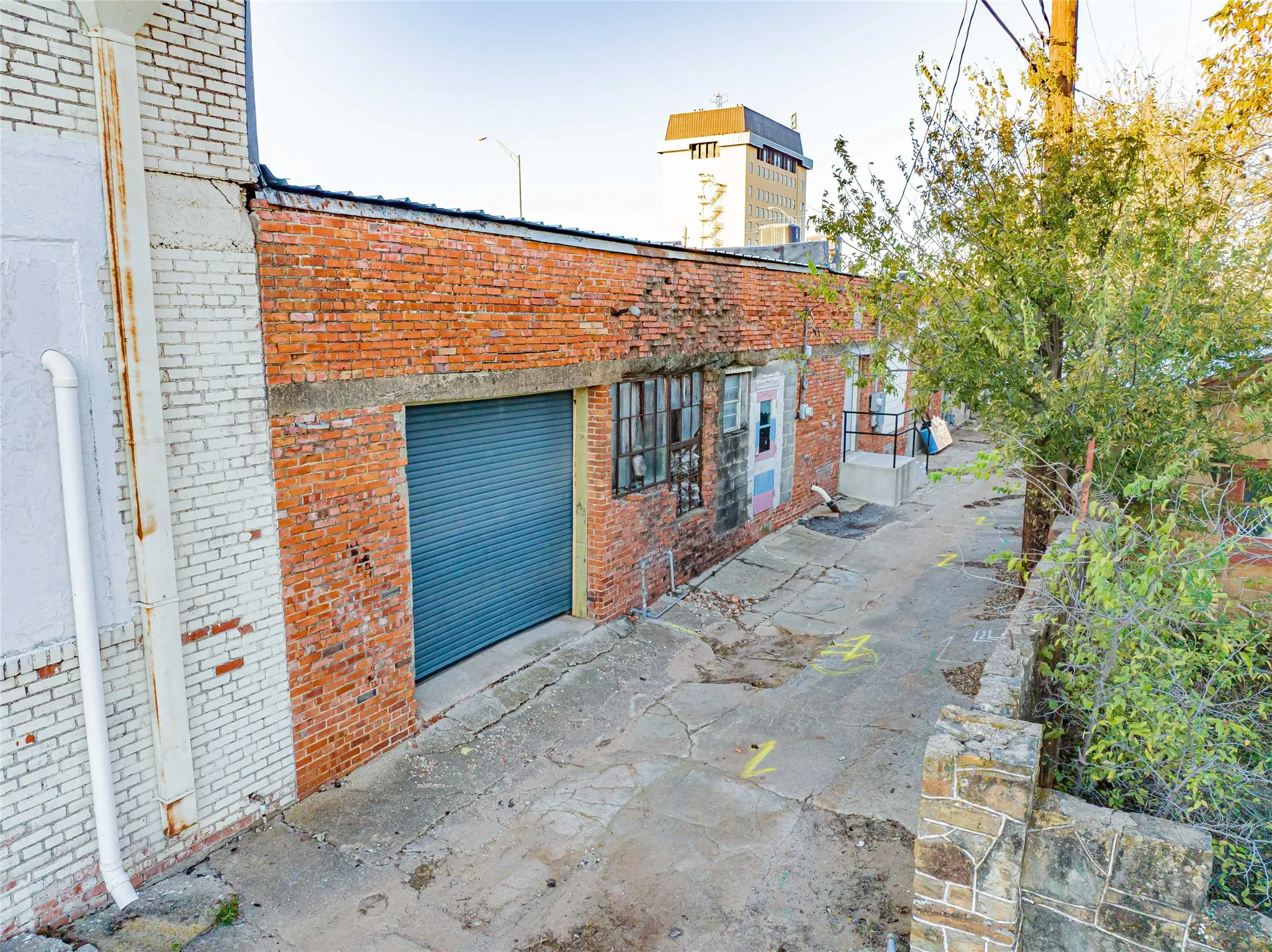 Alley access with rollup-freight door.