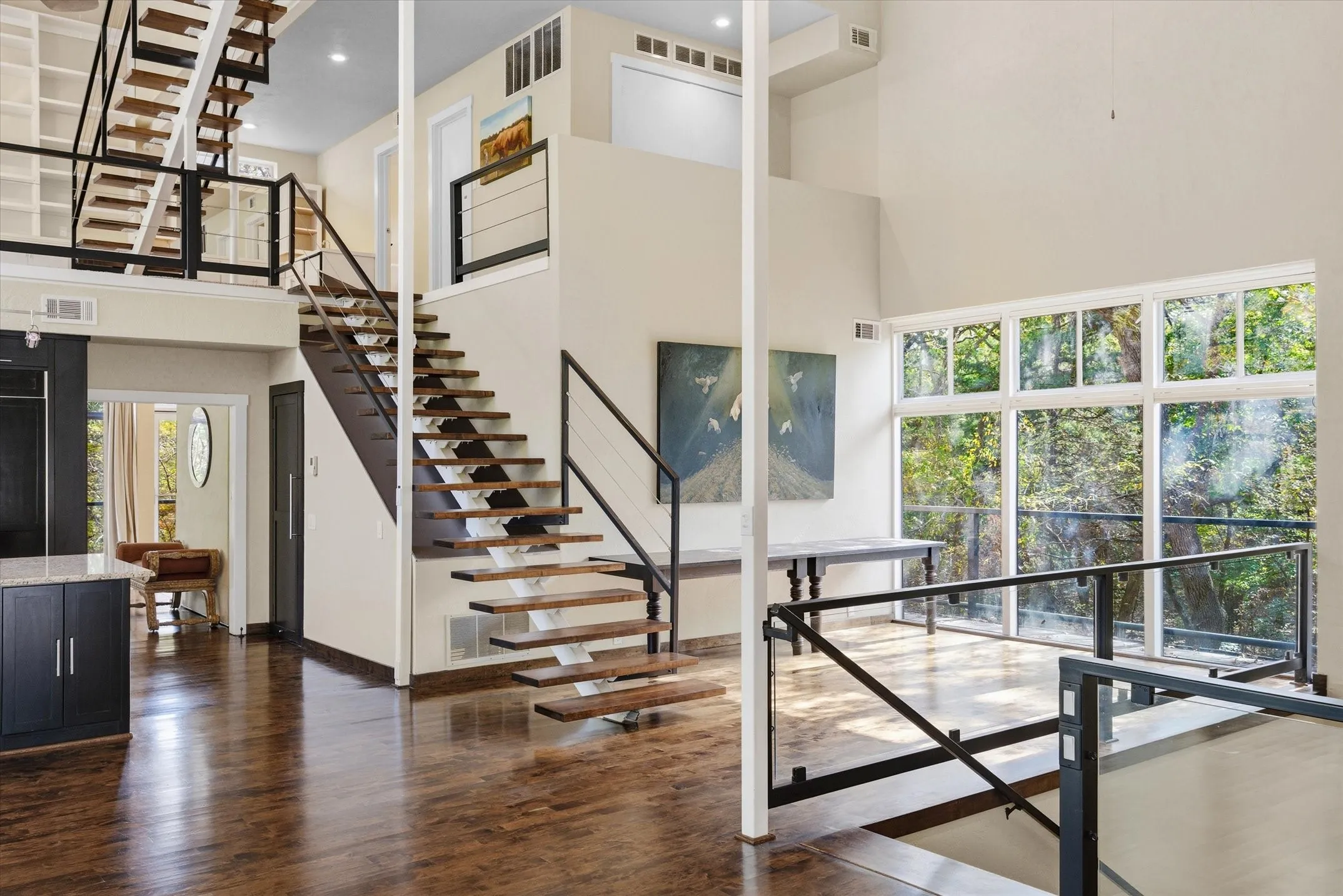 Dining Area with views. Loft is accessed with a floating staircase complete with metal and cable railing