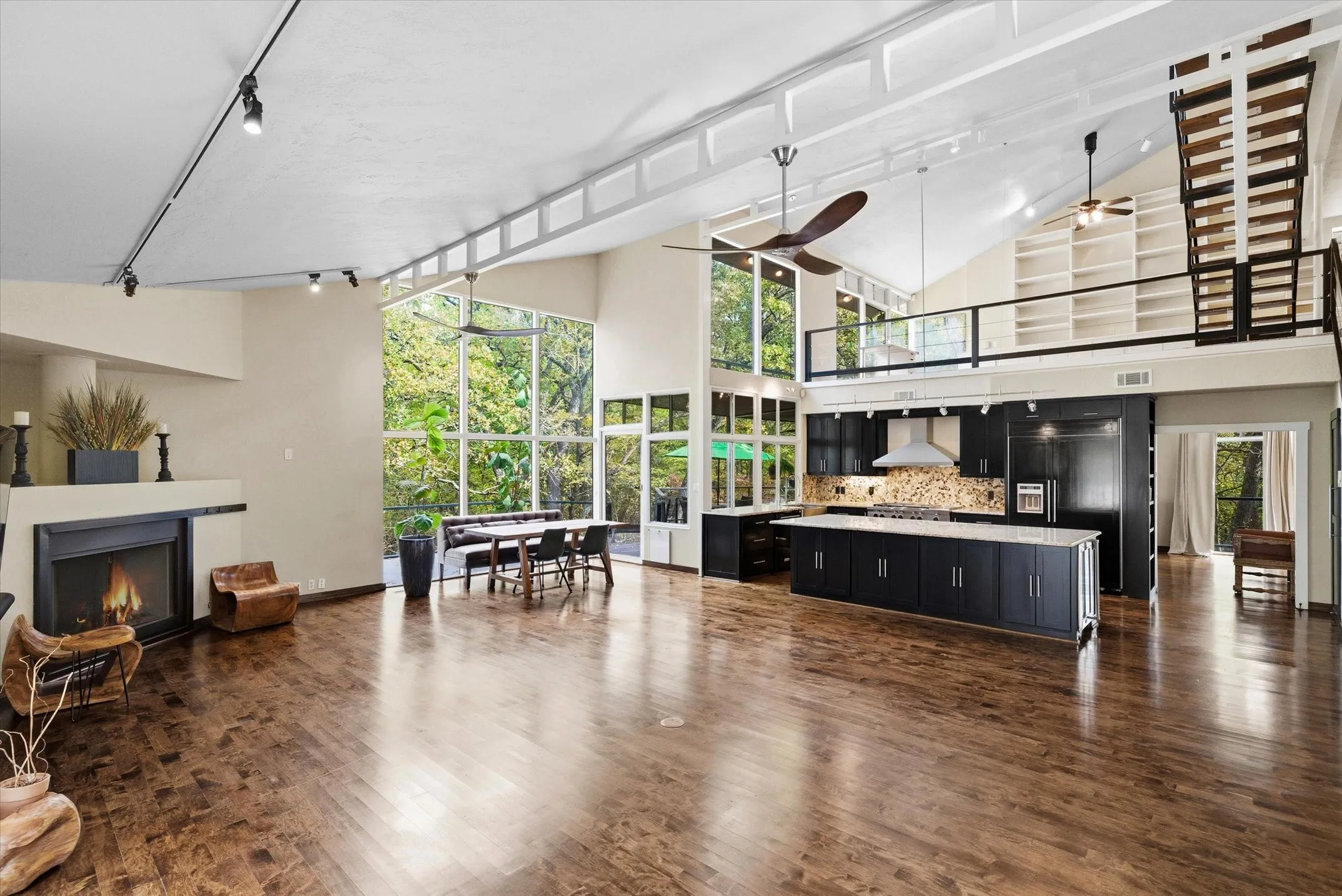 Hardwood floors, banks of windows and soaring ceilings combine for a dramatic Great Room