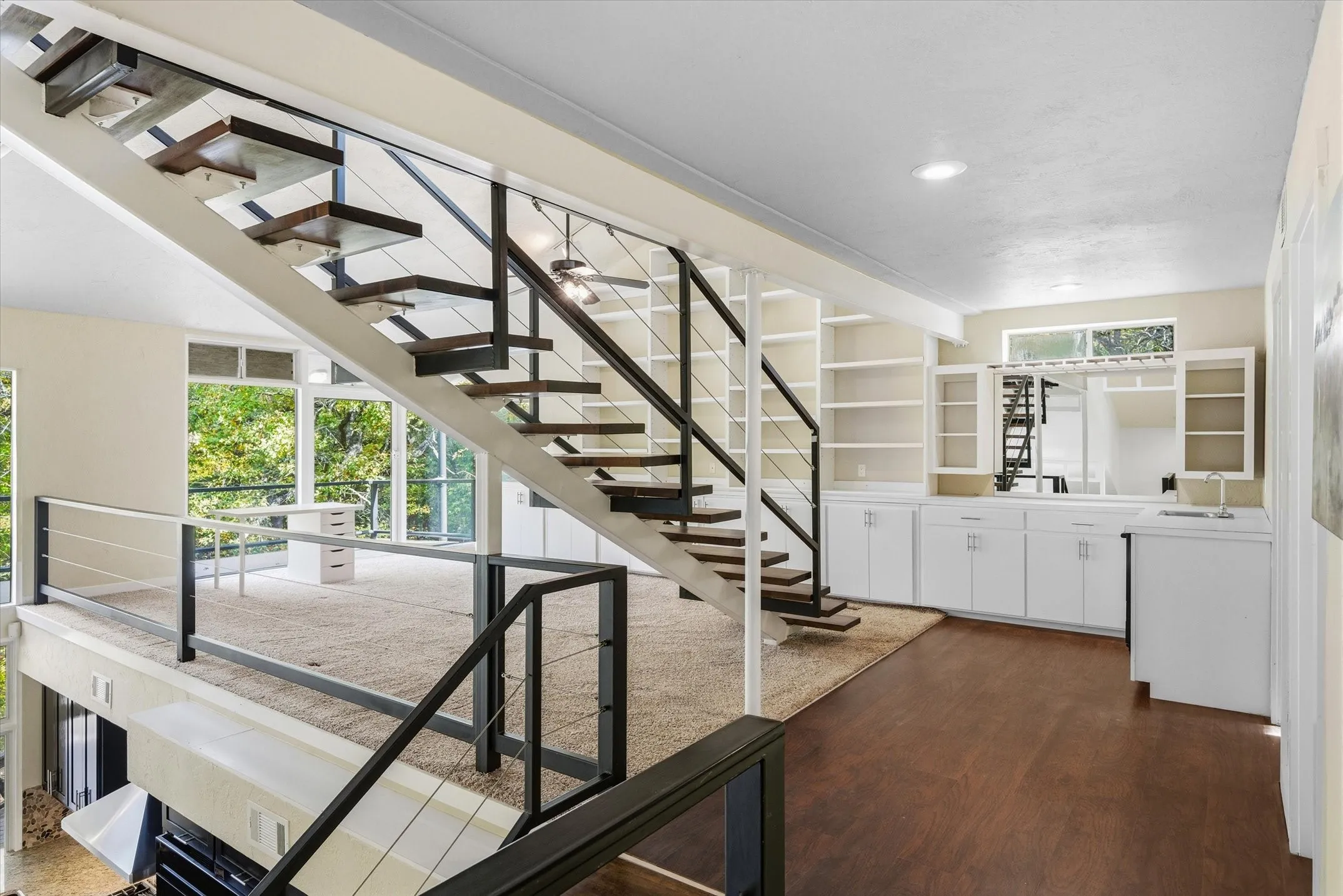 Loft offers floor to ceiling bookshelves, a wet bar, and a bathroom, plus a huge closet. Another set of floating stairs leads to the 4th story