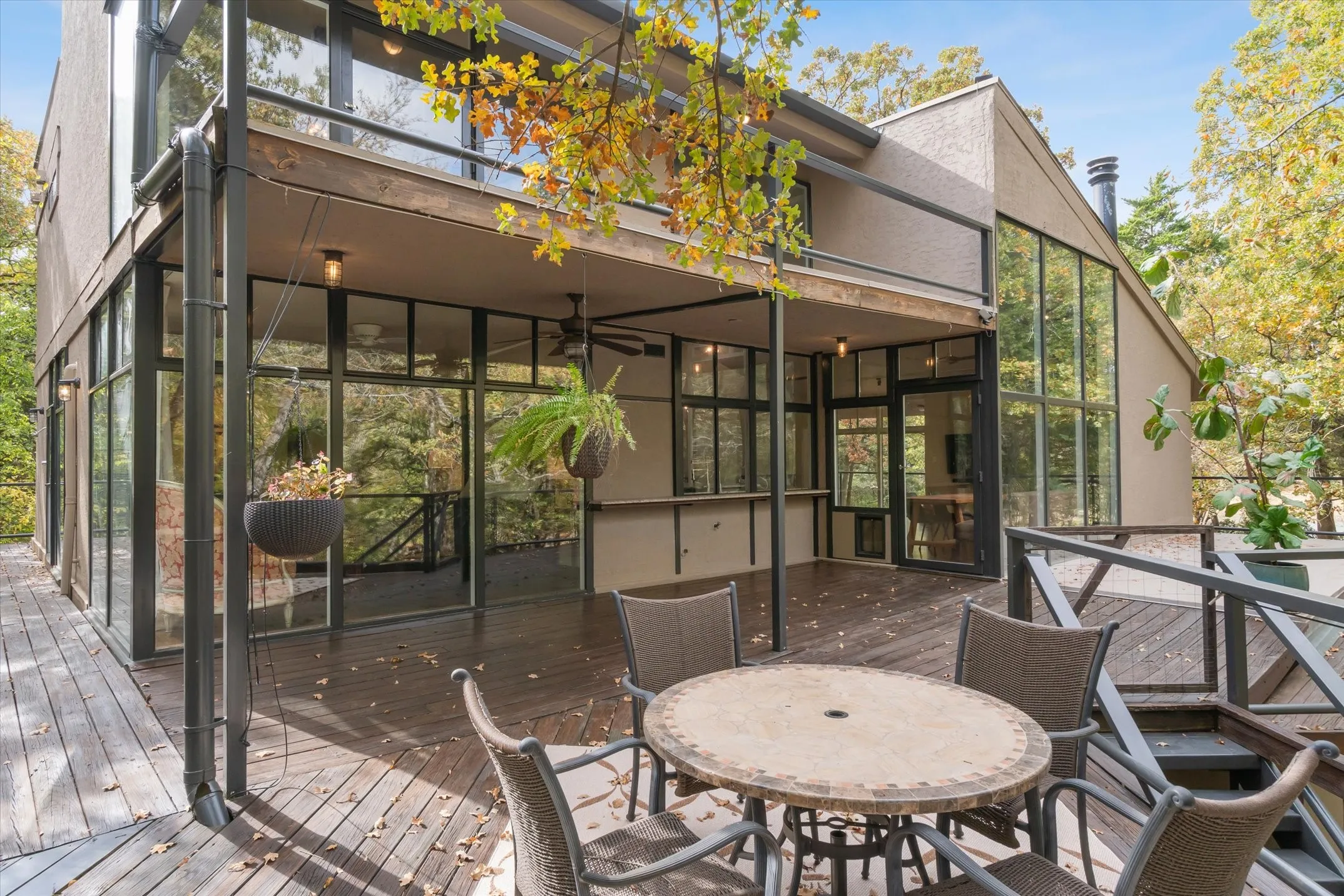 Outdoor Living on the 2nd level with stairs to the patios and woods below.