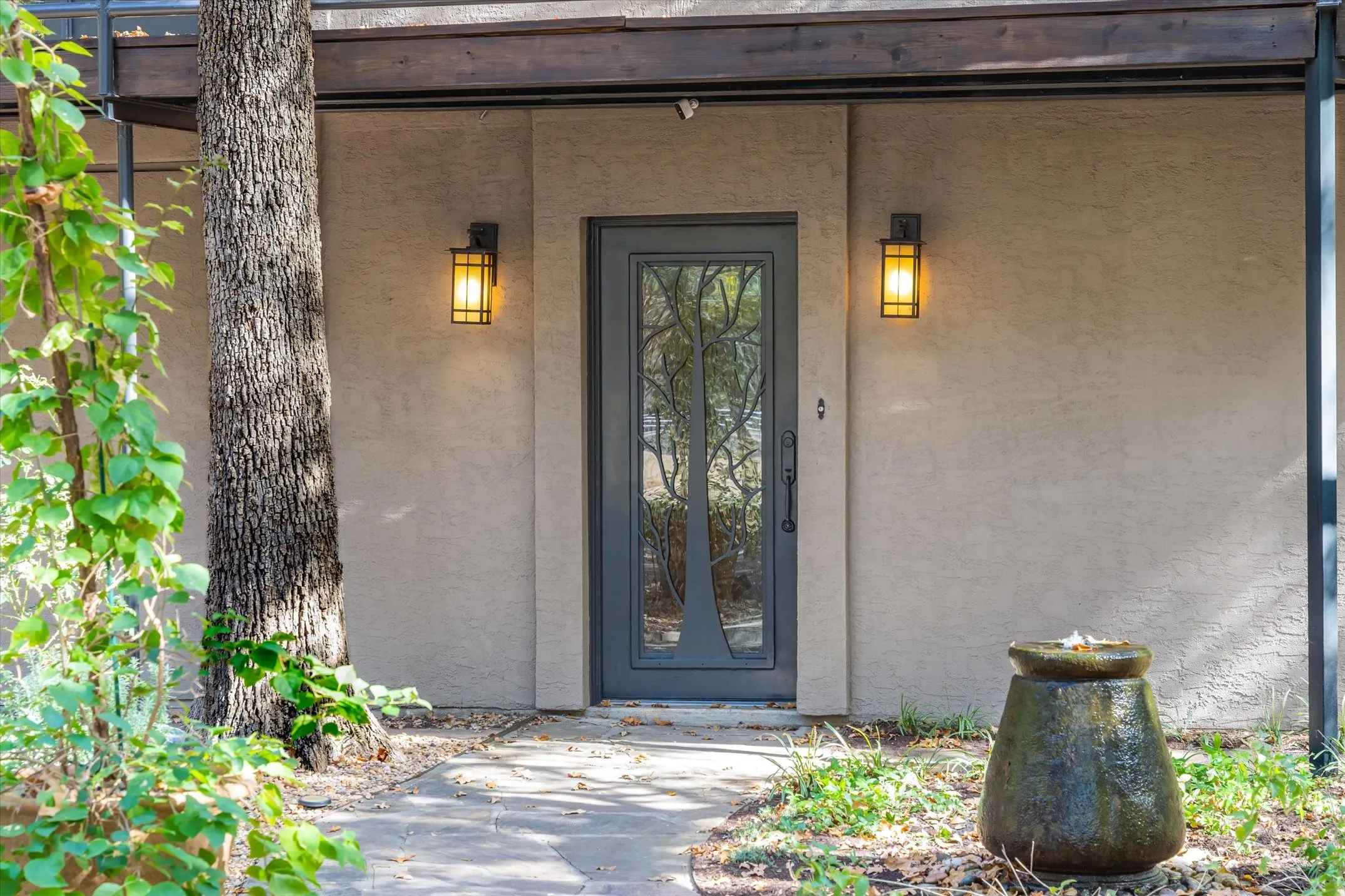 Love the metal art door with a tree theme leading to the Ground Floor Entry