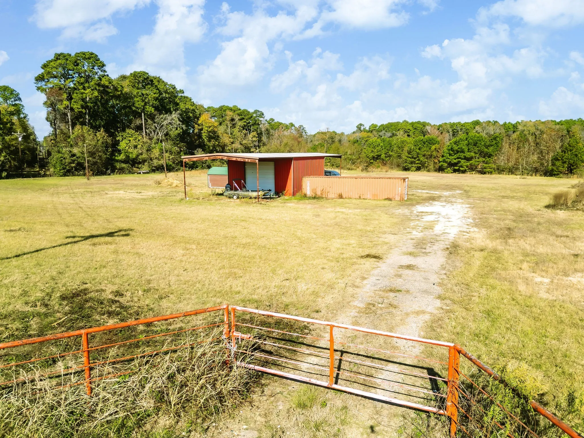View of yard with an outbuilding, a view of rural / pastoral area, an outdoor structure, and driveway