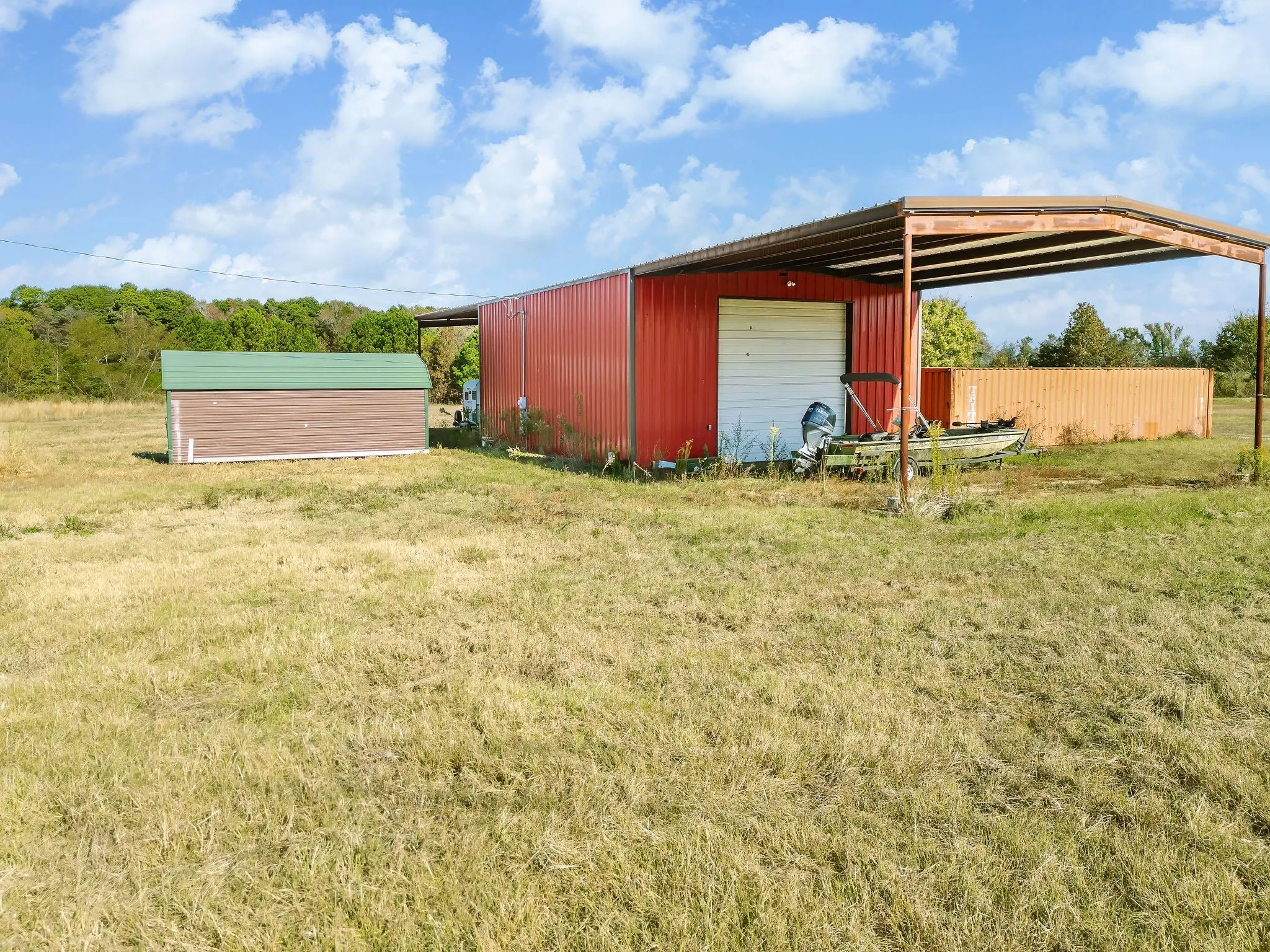 View of pole building with a yard