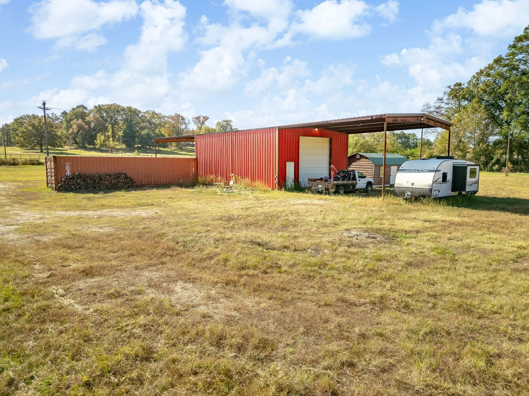 View of pole building with a yard