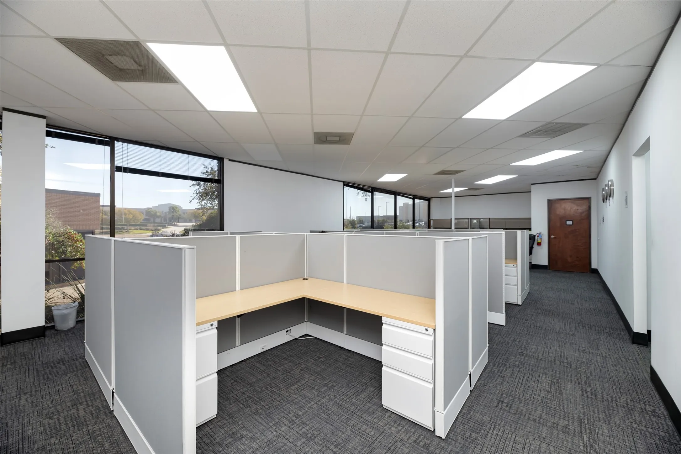 Unfurnished office with a paneled ceiling and built in study area