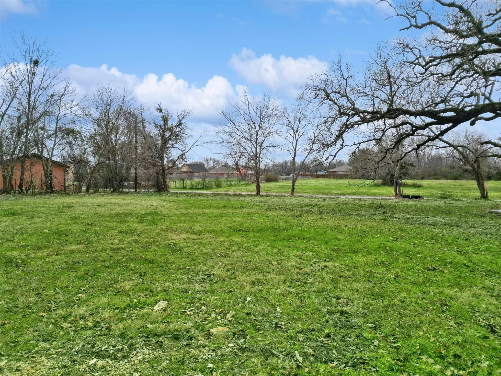 View of green lawn with a rural view