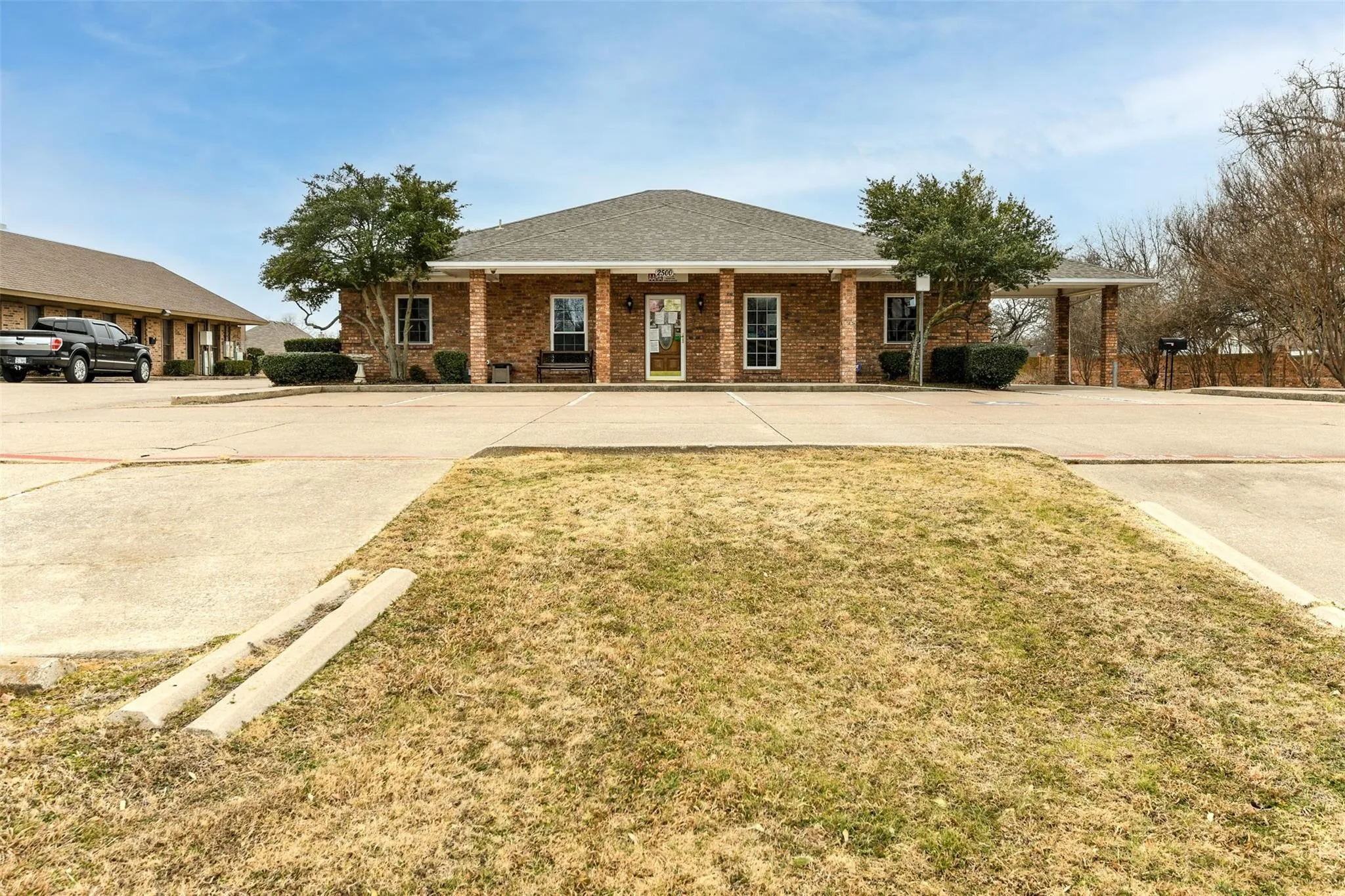 Ranch-style house with brick siding, a front yard, and a porch