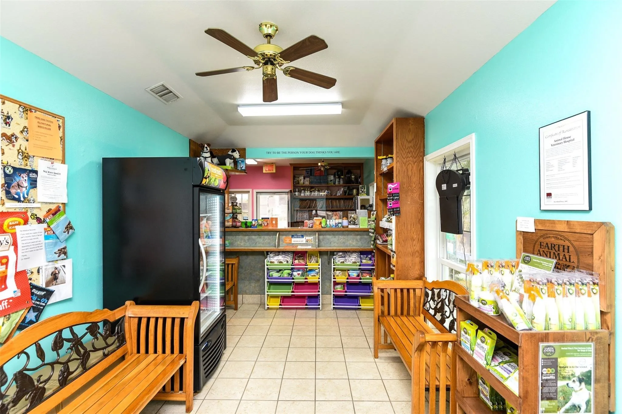 Kitchen with light tile patterned floors, a ceiling fan, and black refrigerator