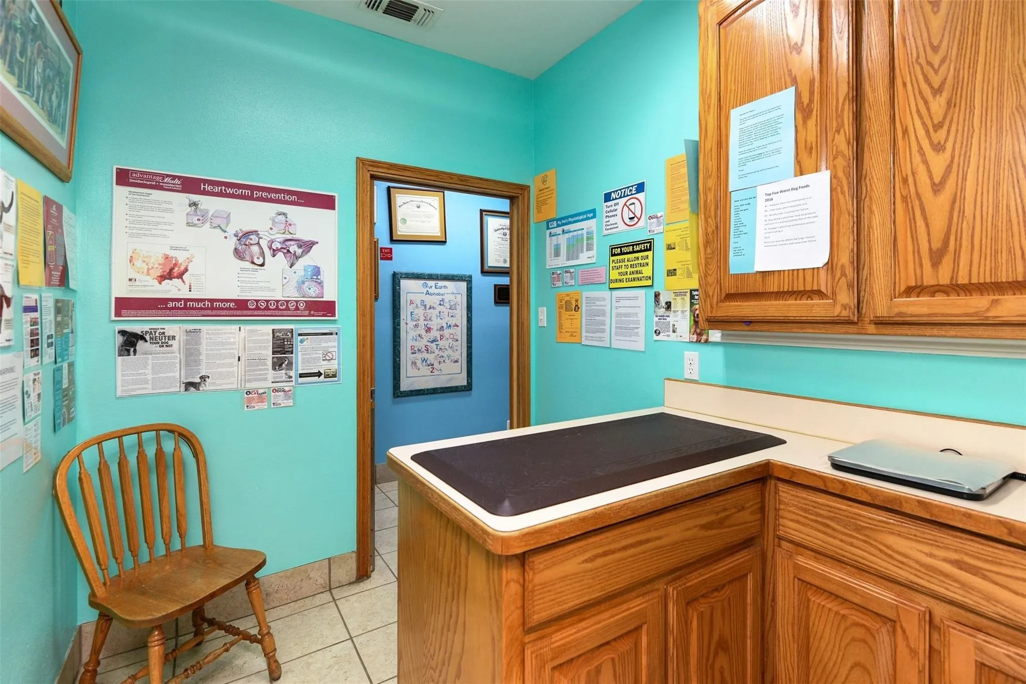 Kitchen featuring brown cabinetry, light tile patterned flooring, and light countertops