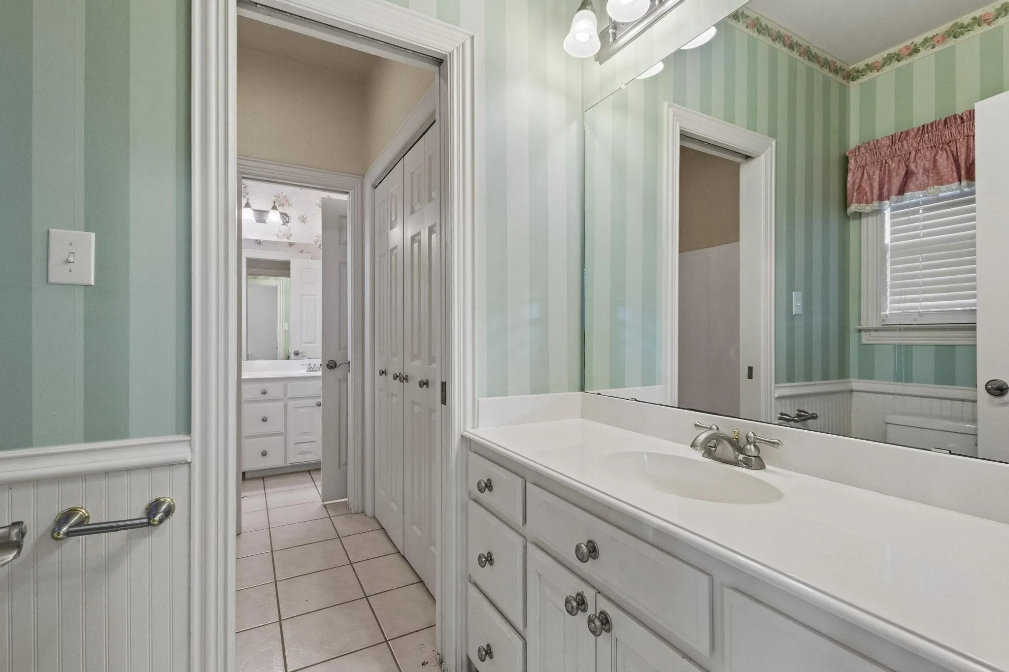 Jack & Jill bath with commode & sink, shower shared with other bedroom