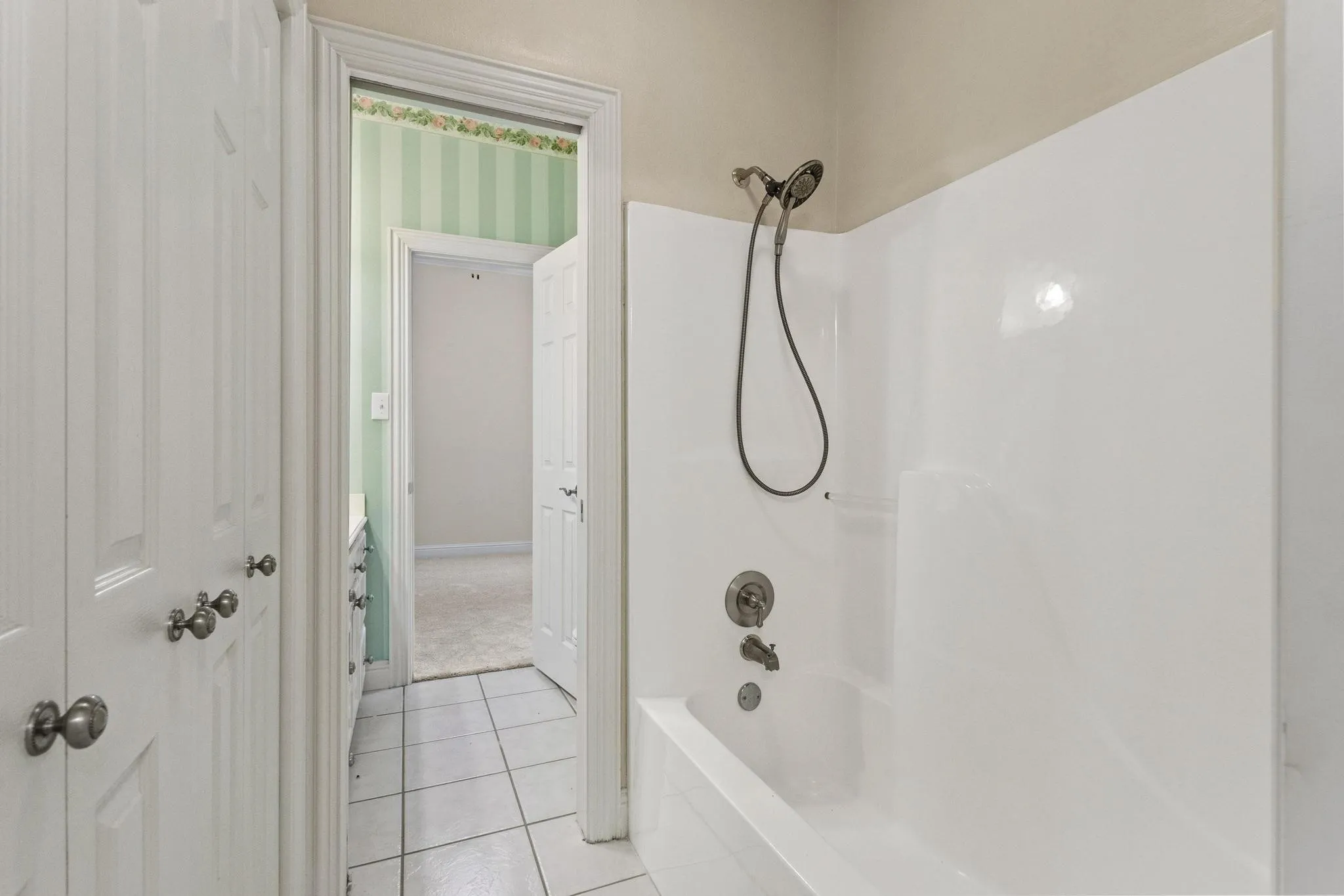 Shower located between 2 bedrooms with private sinks & commodes on both sides
