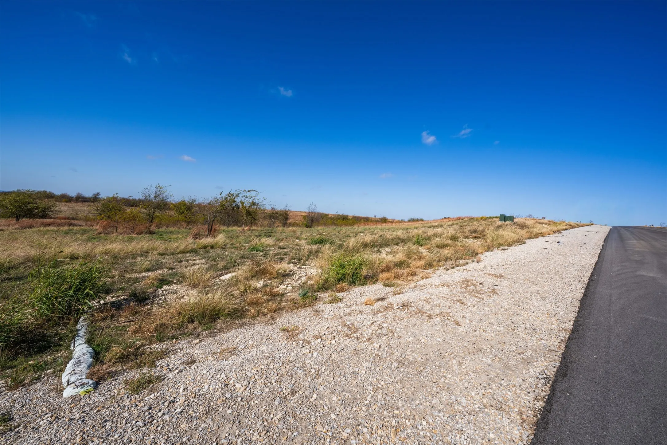 View of asphalt road with a view of rural / pastoral area
