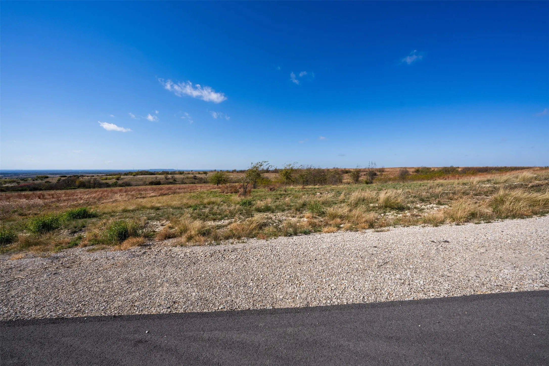 View of asphalt road featuring a rural view