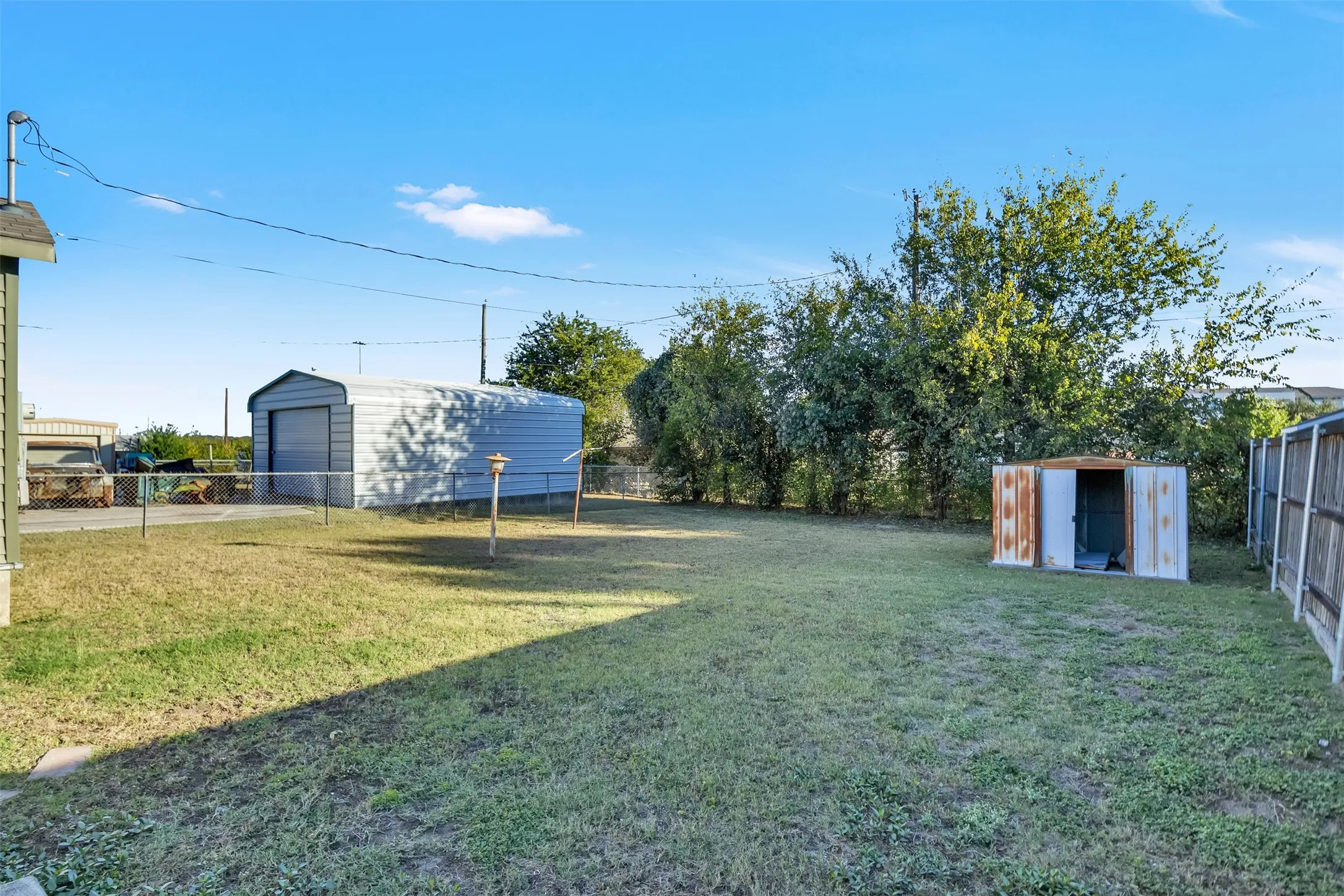 Fenced backyard with a storage unit