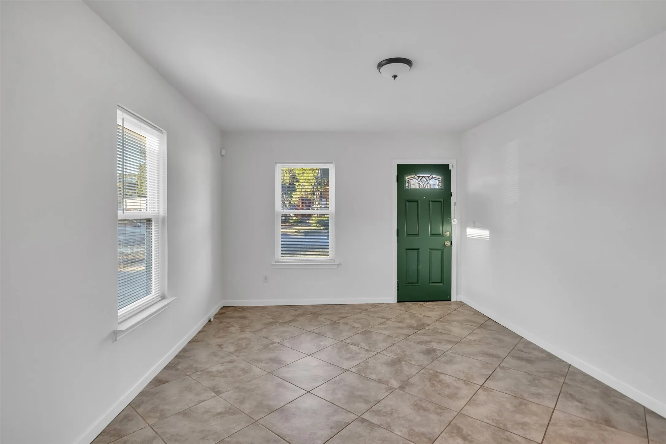 Foyer entrance with light tile patterned floors