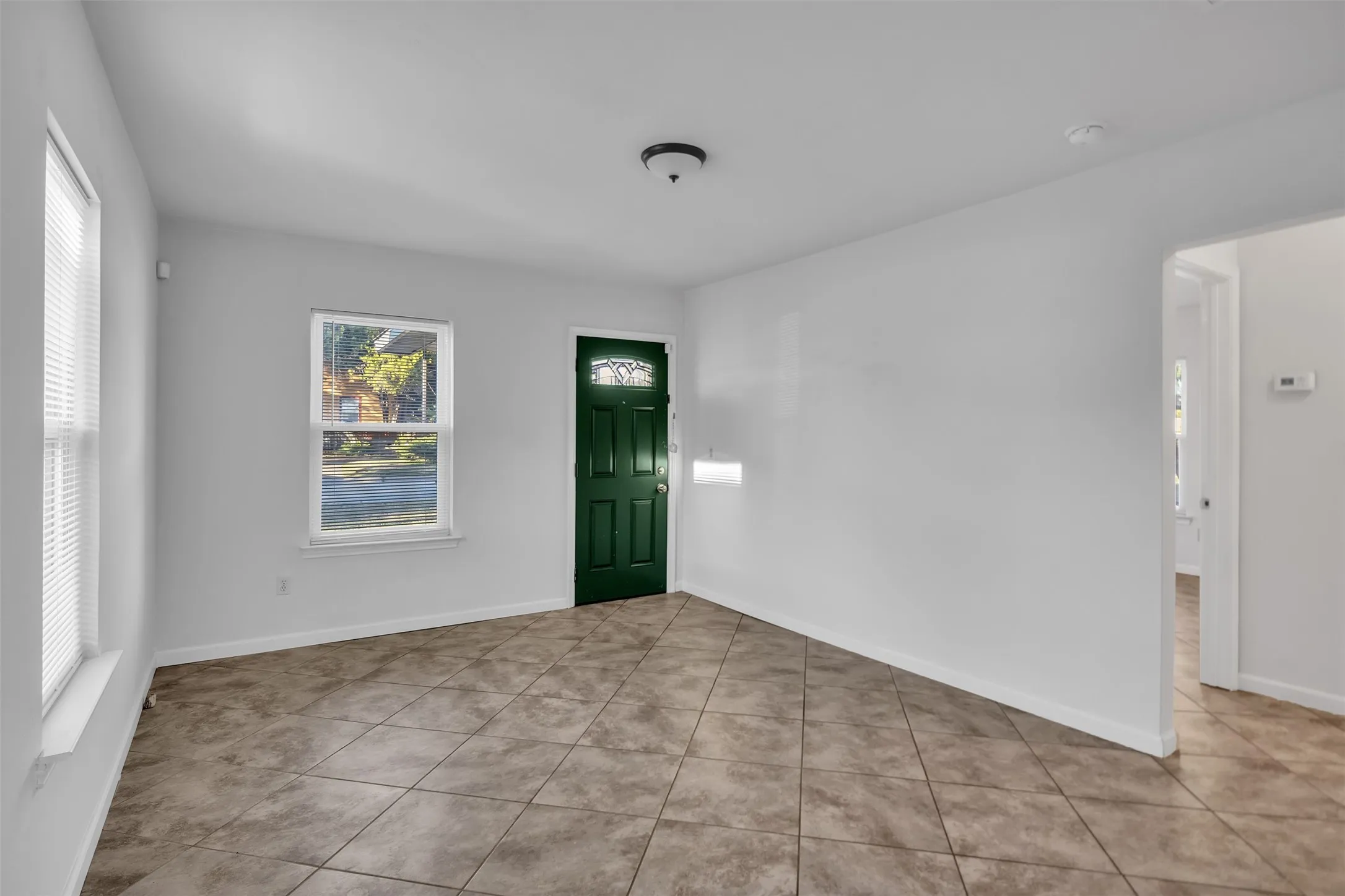 Entryway featuring tile patterned floors and baseboards