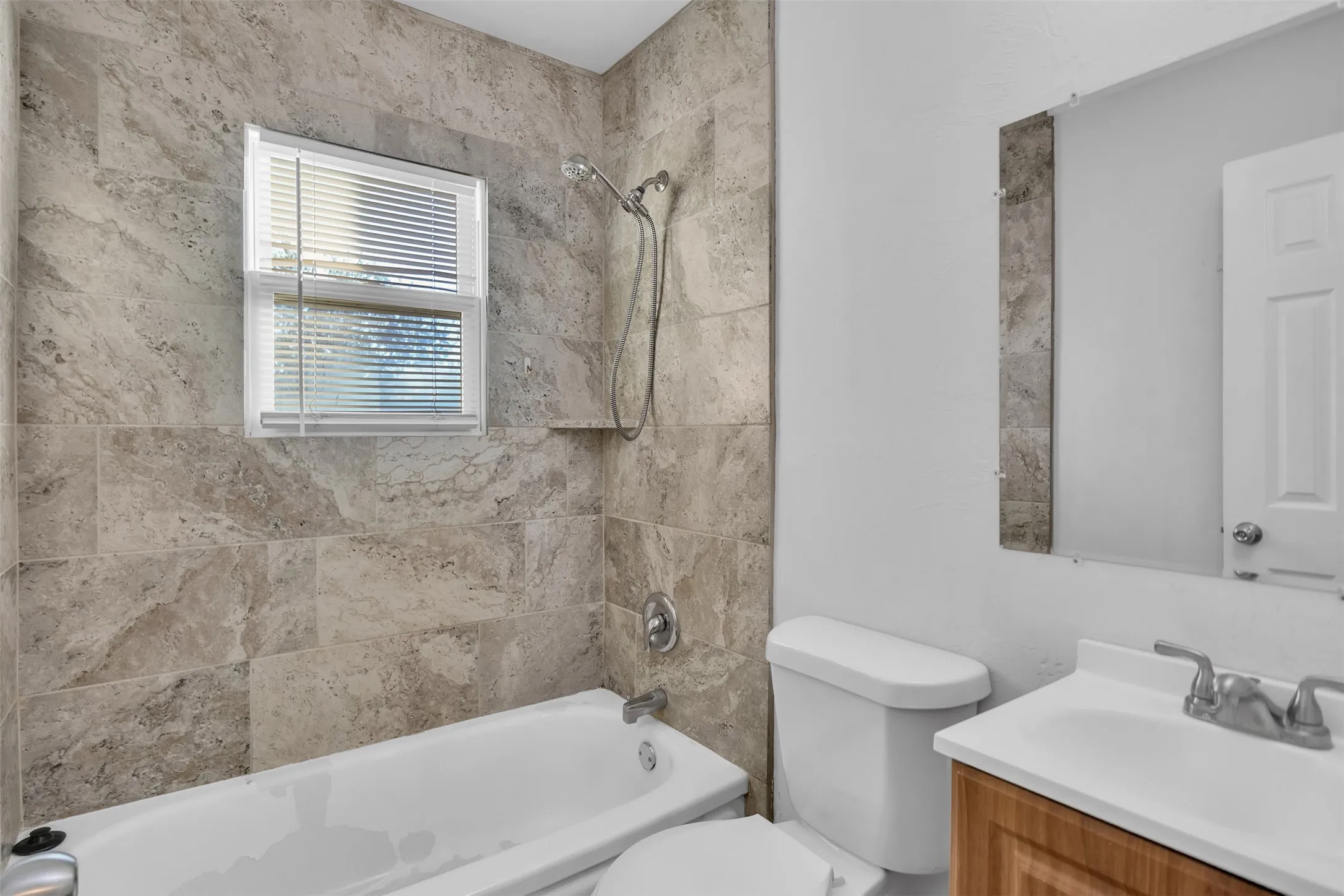 Bathroom with washtub / shower combination and vanity