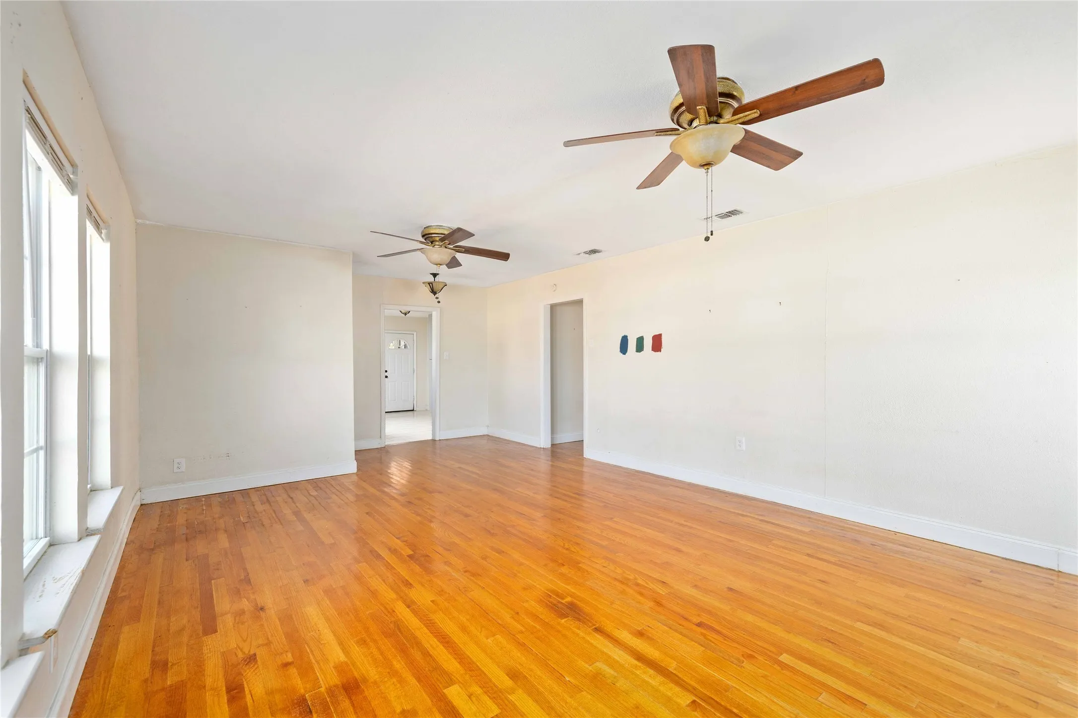 light wood finished floors and a ceiling fan