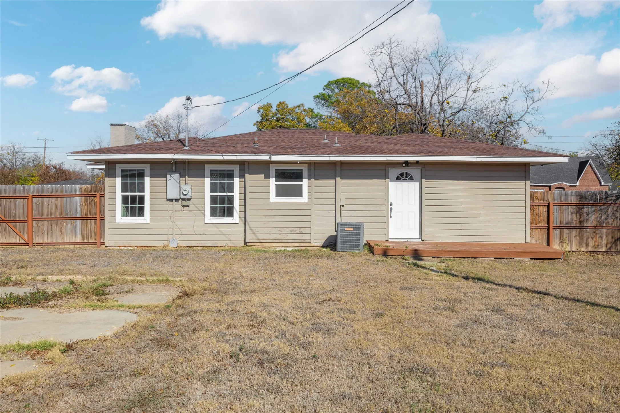 Back of property with a chimney and a deck