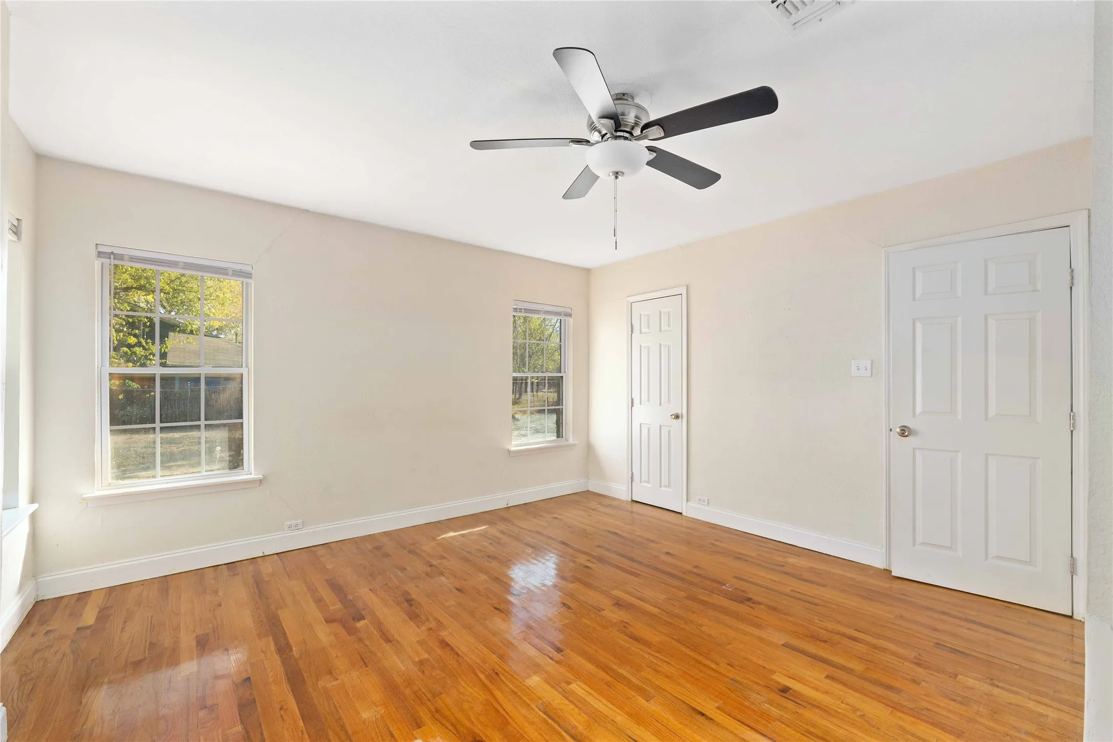 Empty room featuring light wood-style floors and ceiling fan