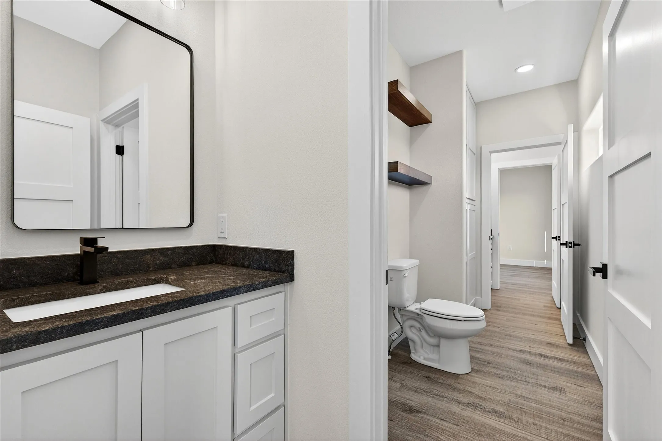 Half bath with vanity, light wood-style floors, and recessed lighting