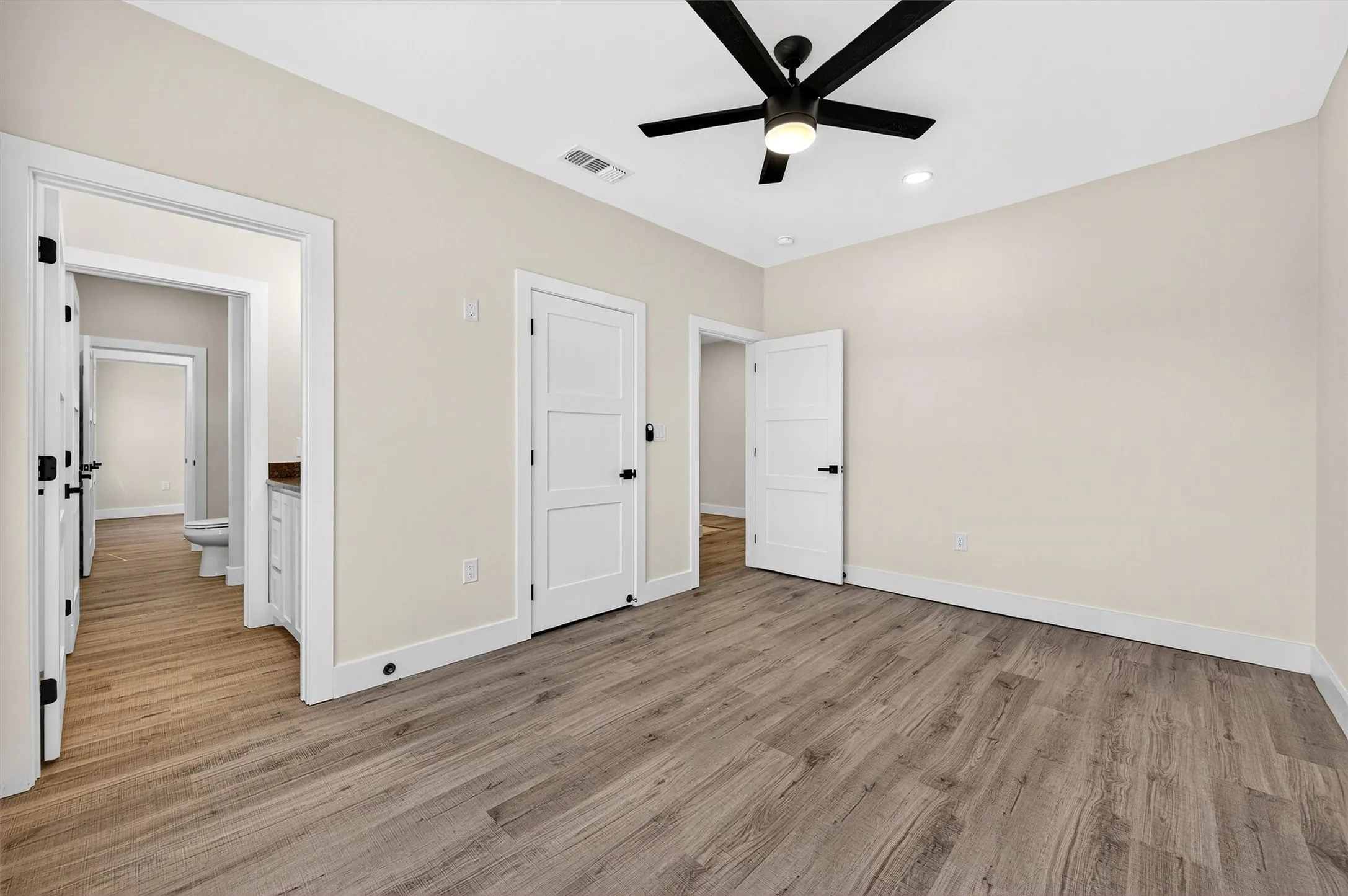 Unfurnished bedroom featuring light wood-style floors, ceiling fan, and recessed lighting