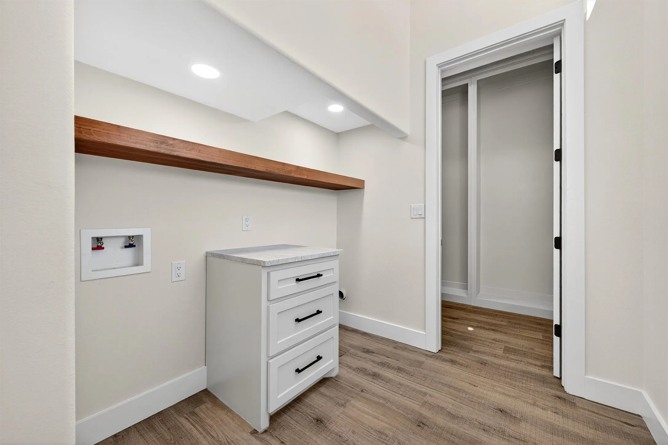 Washroom with hookup for a washing machine, light wood-type flooring, and recessed lighting